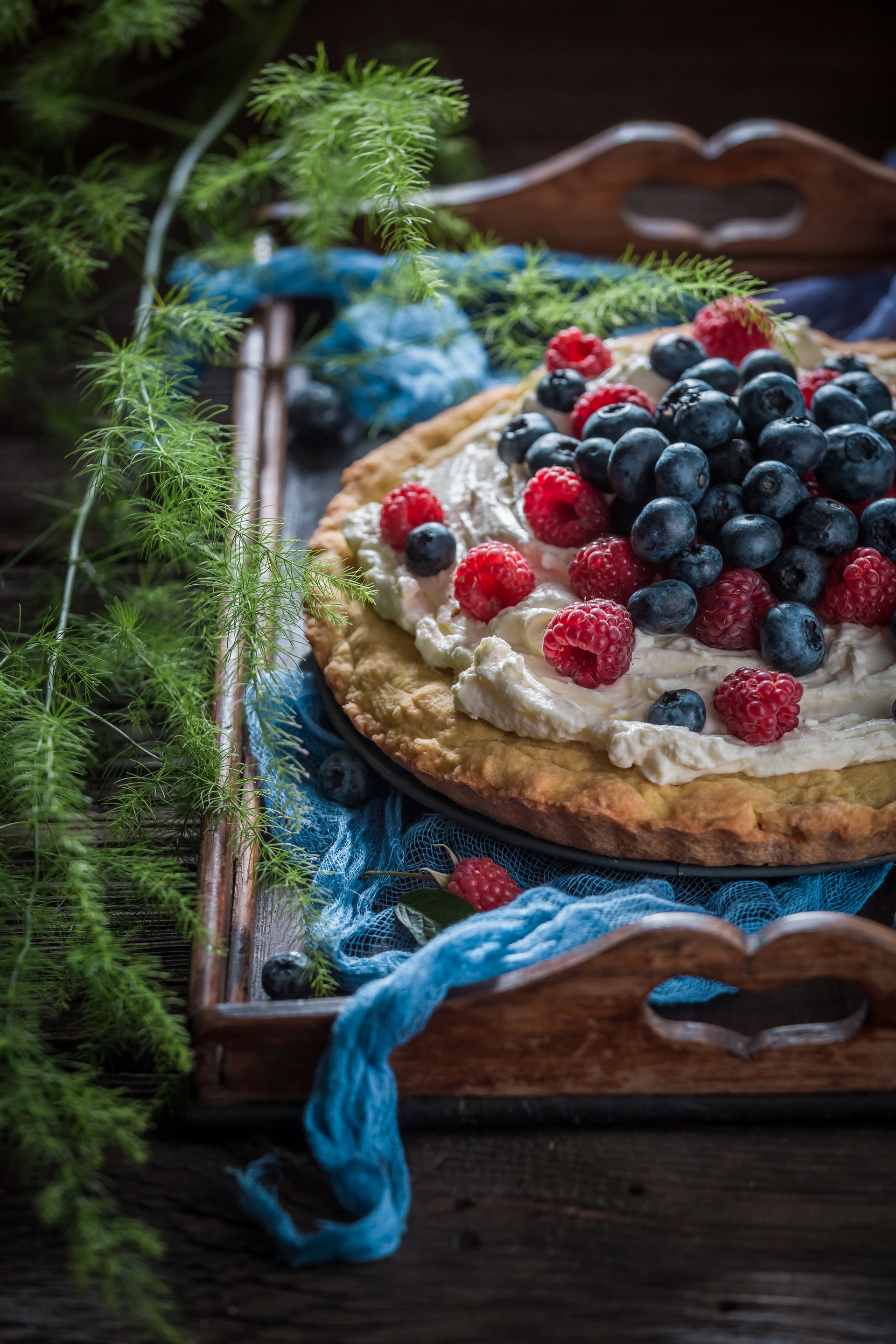 Overhead flat-lay of all ingredients for Icelandic Skyr Cake with Wild Berries laid out on a kitchen surface.