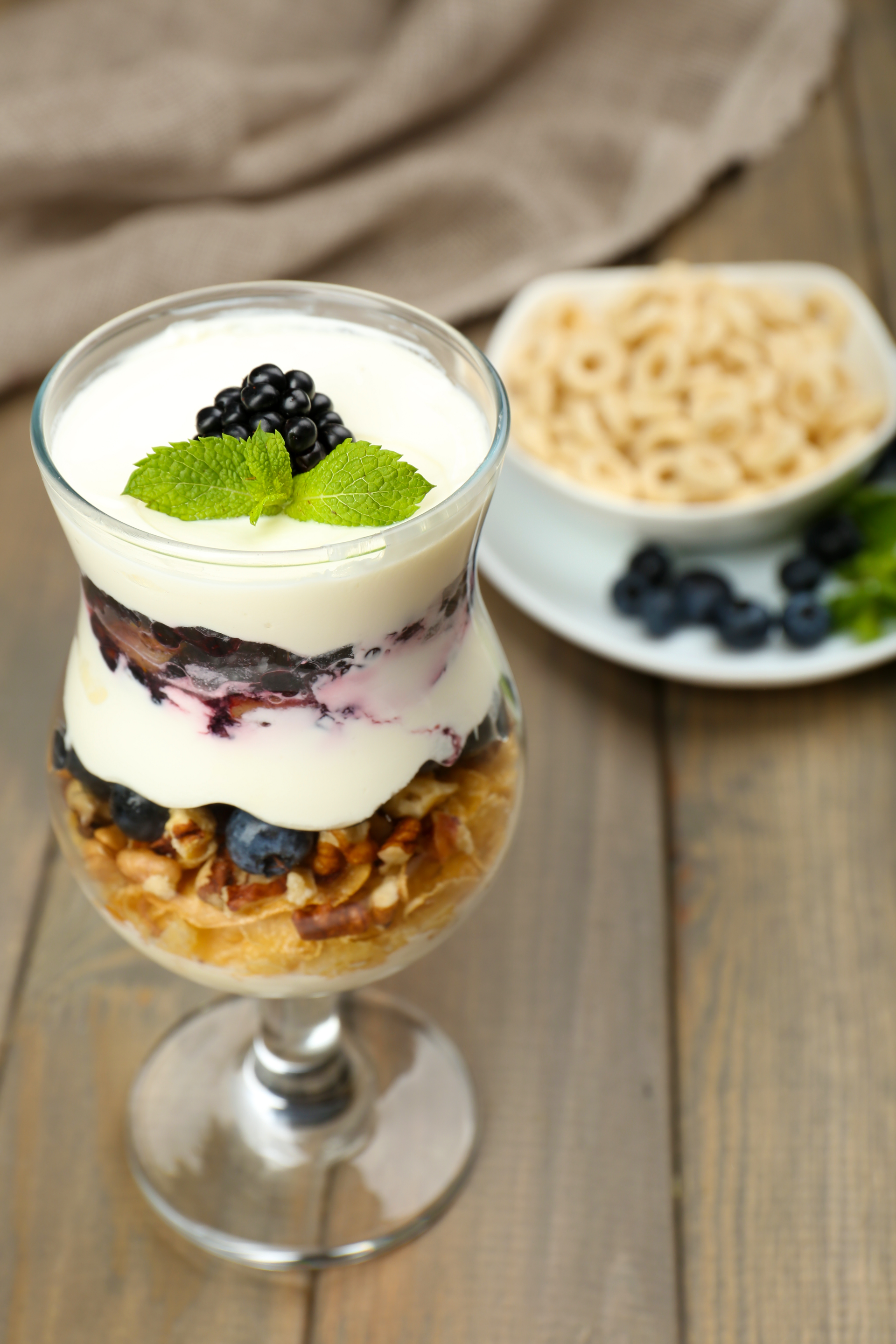 Overhead flat-lay of all ingredients for Icelandic Skyr Parfait with Cardamom Blueberry Sauce laid out on a kitchen surface.