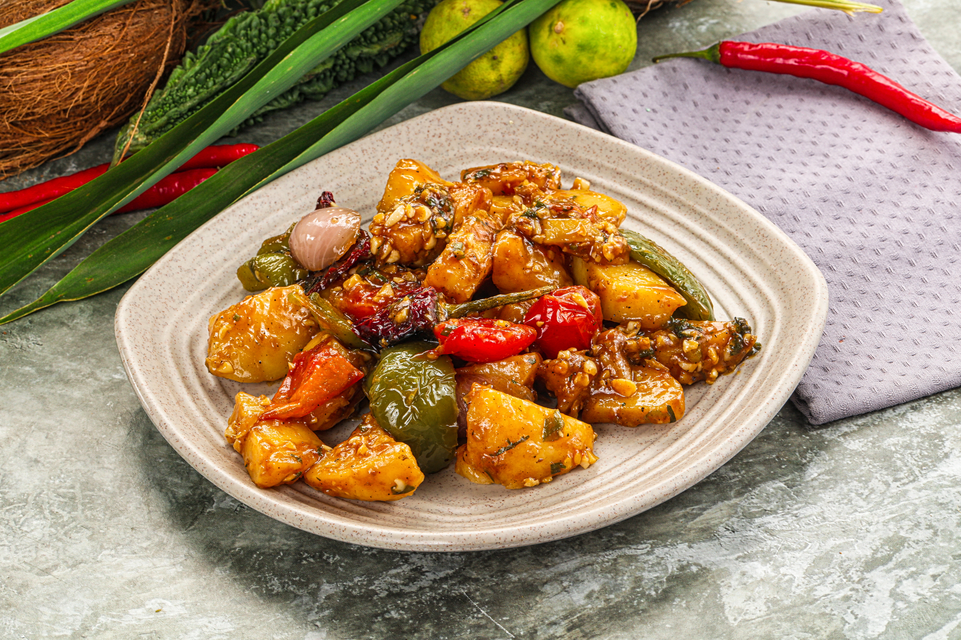 Overhead flat-lay of all ingredients for Indonesian Belado Balado with Fried Tofu and Potato laid out on a kitchen surface.