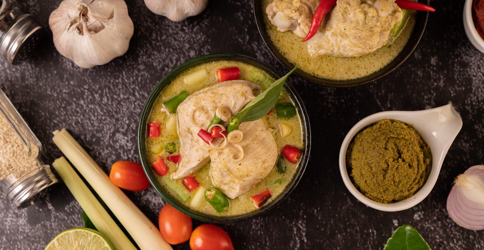 Overhead flat-lay of all ingredients for Indonesian Opor Ayam with Coconut Sauce and Spices laid out on a kitchen surface.