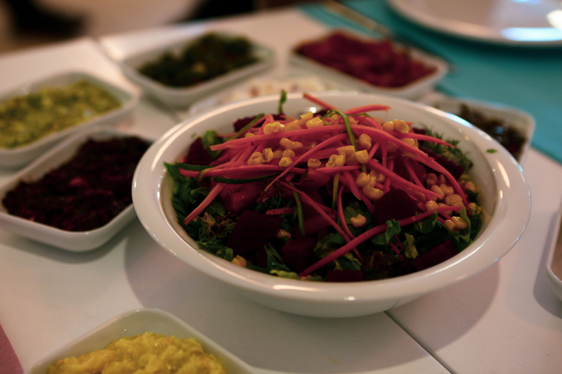 Overhead flat-lay of all ingredients for Indonesian Rujak Salad with Spicy Tamarind Dressing laid out on a kitchen surface.