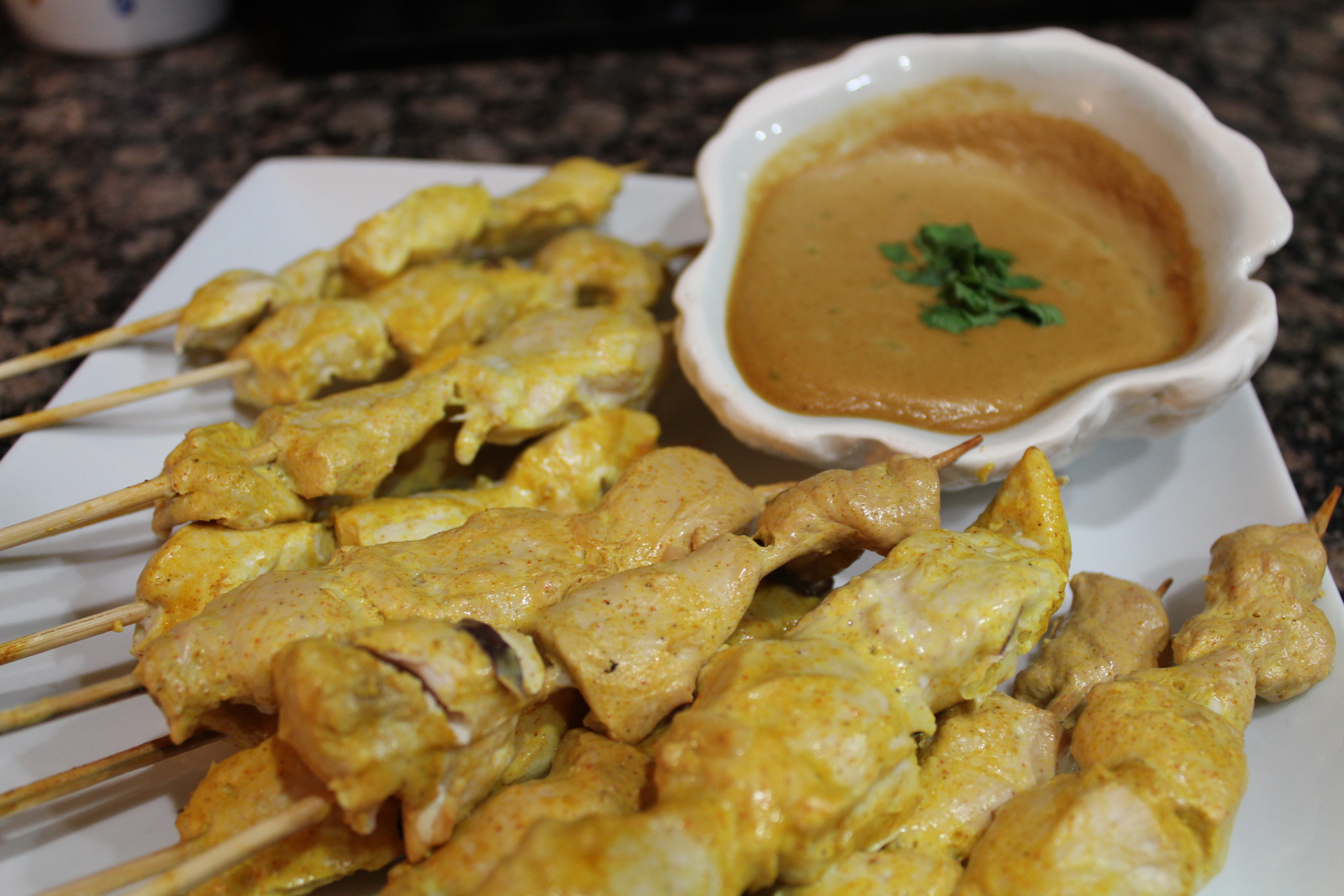 Overhead flat-lay of all ingredients for Indonesian Satay Ayam with Spicy Peanut Sauce laid out on a kitchen surface.