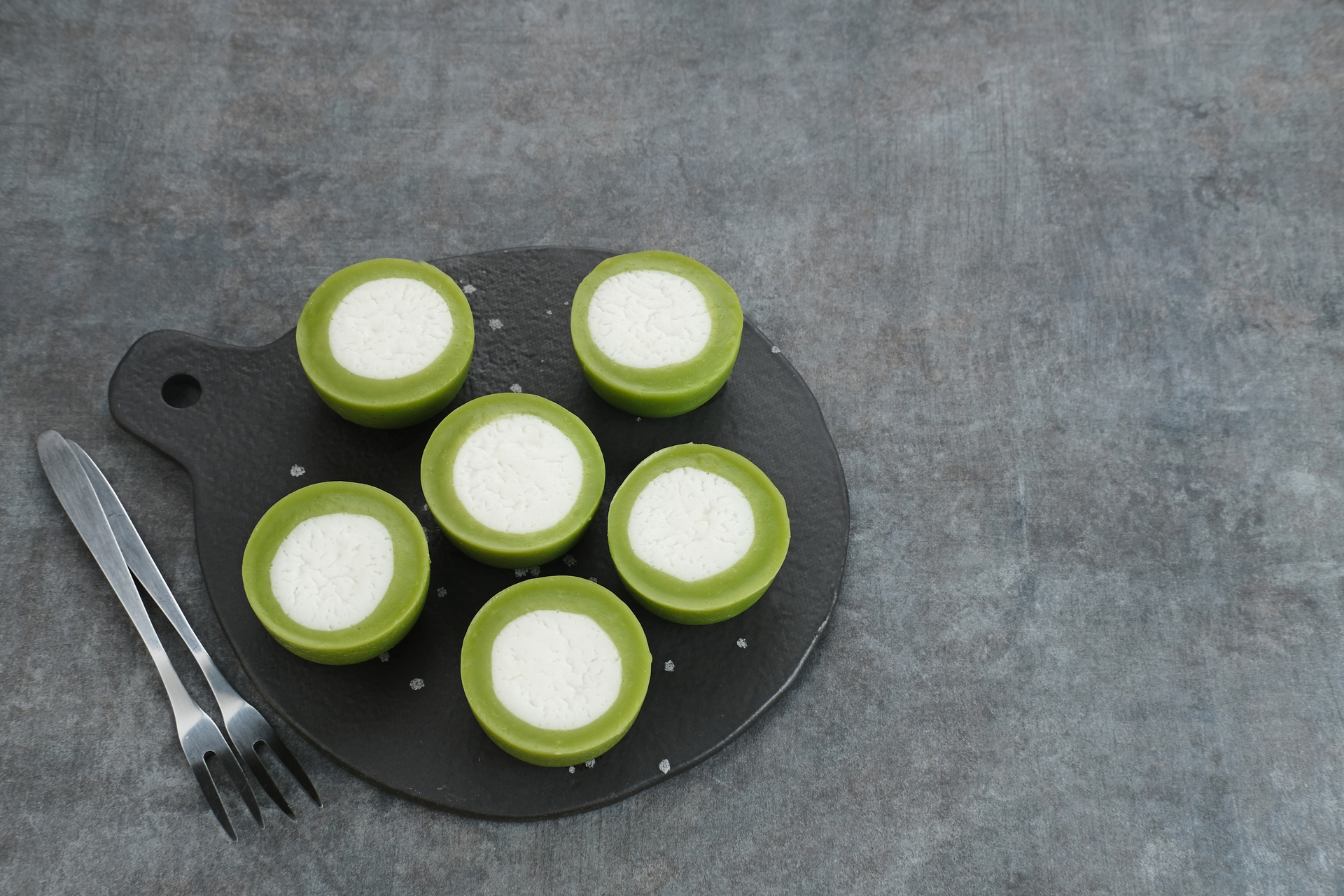 Overhead flat-lay of all ingredients for Indonesian Serabi with Pandan Coconut Sauce laid out on a kitchen surface.