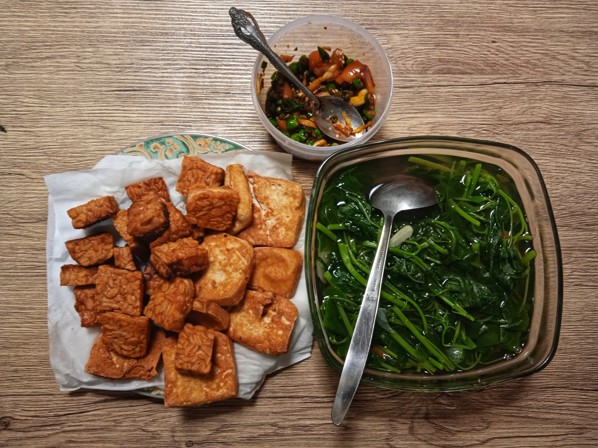 Overhead flat-lay of all ingredients for Indonesian Tamarind-Glazed Tempeh with Toasted Sesame laid out on a kitchen surface.