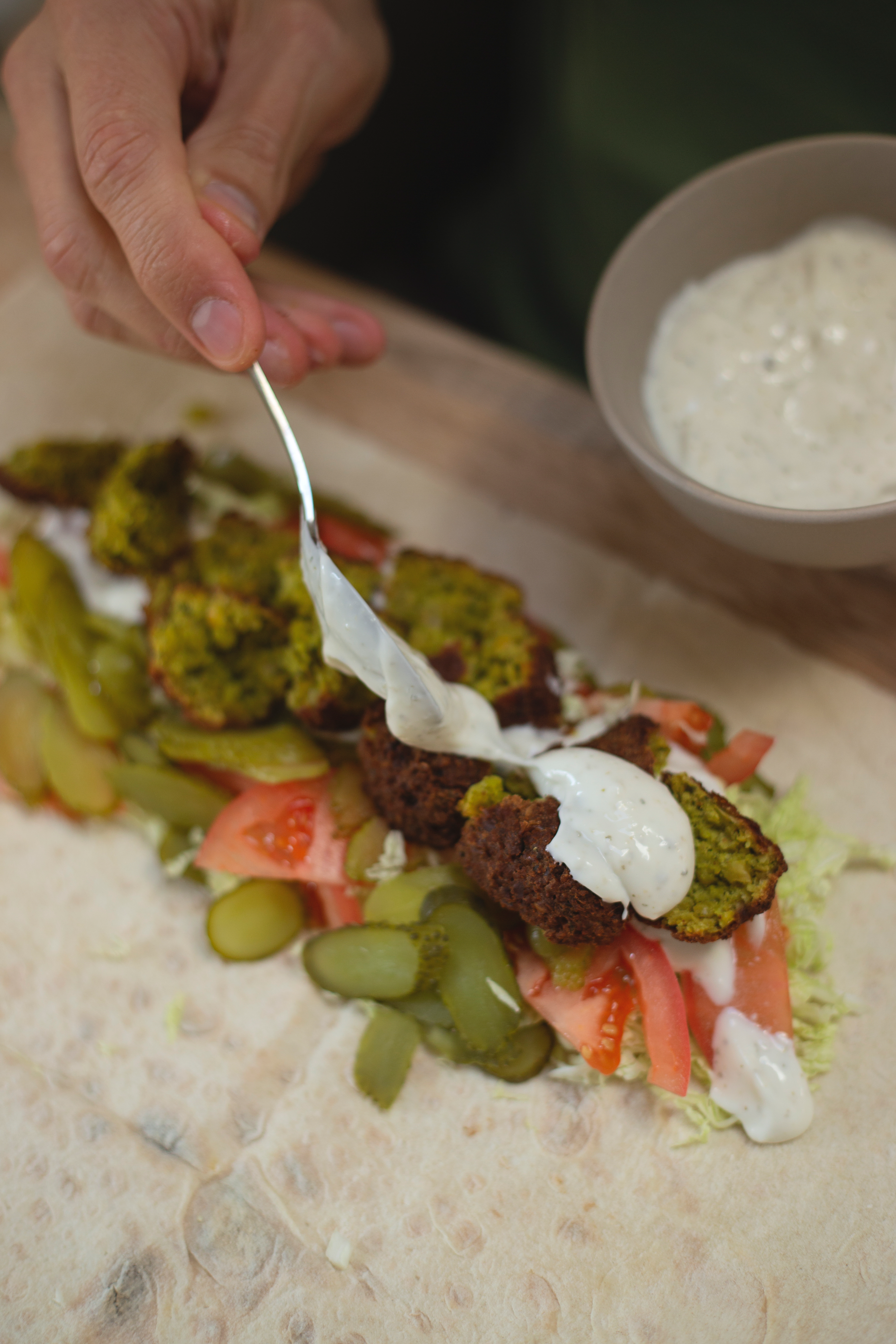 Overhead flat-lay of all ingredients for Israeli Sumac-Dusted Shawarma Skewers with Yogurt Herb Dip laid out on a kitchen surface.