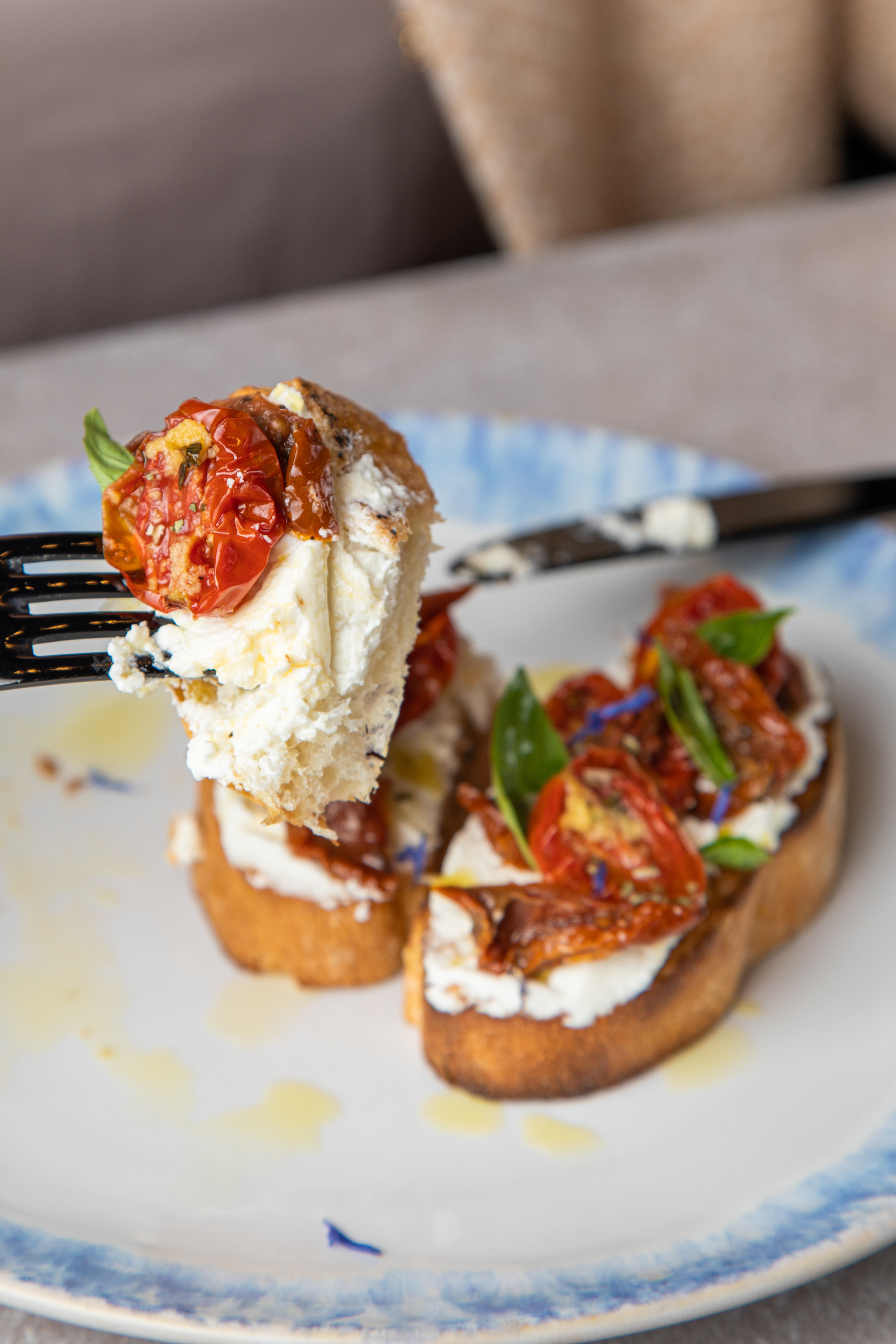 Overhead flat-lay of all ingredients for Italian Burrata Bruschetta with Balsamic Drizzle laid out on a kitchen surface.