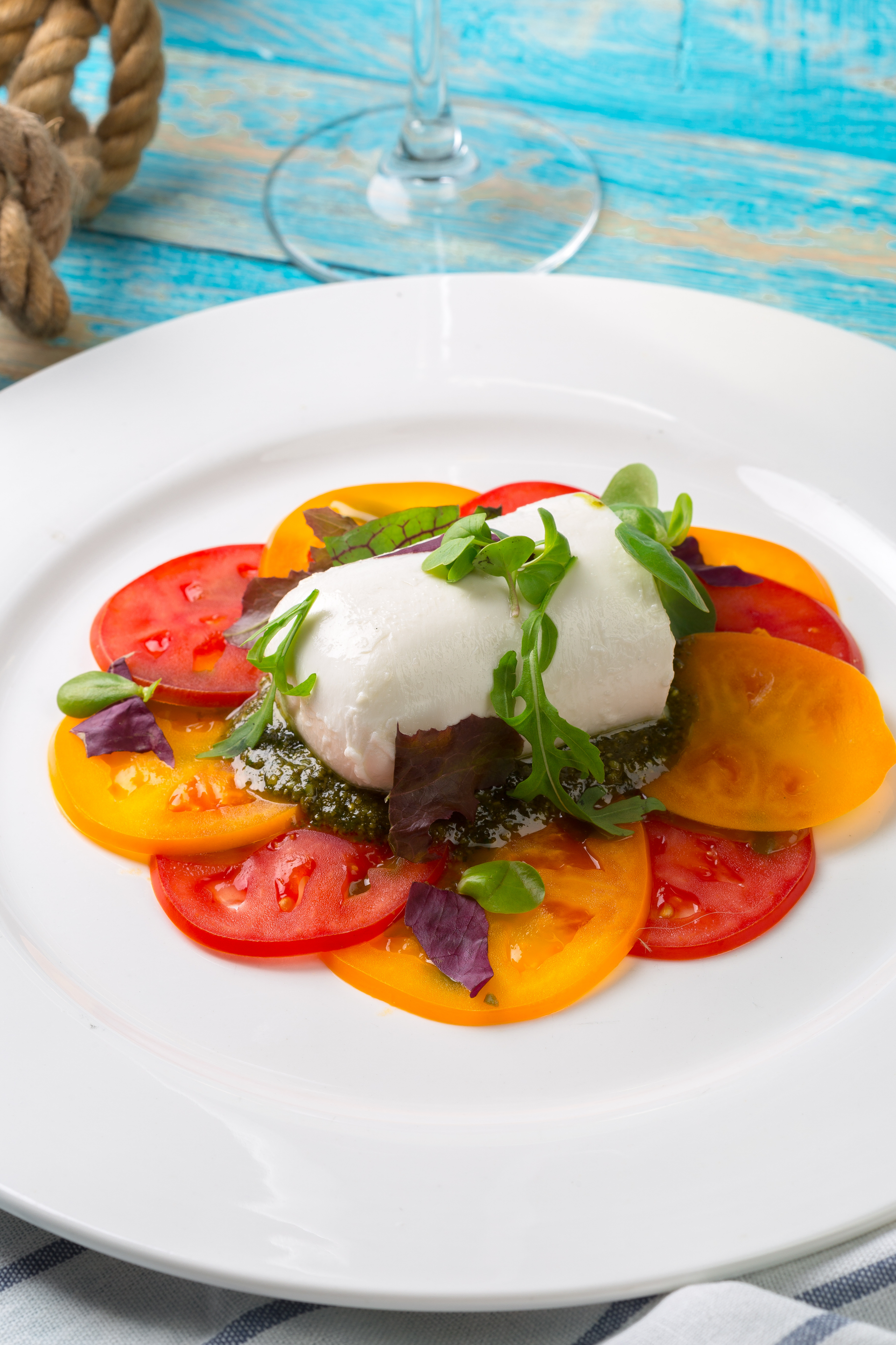 Italian Herb-Infused Burrata Salad with Balsamic Reduction — Appetizer served and photographed from above