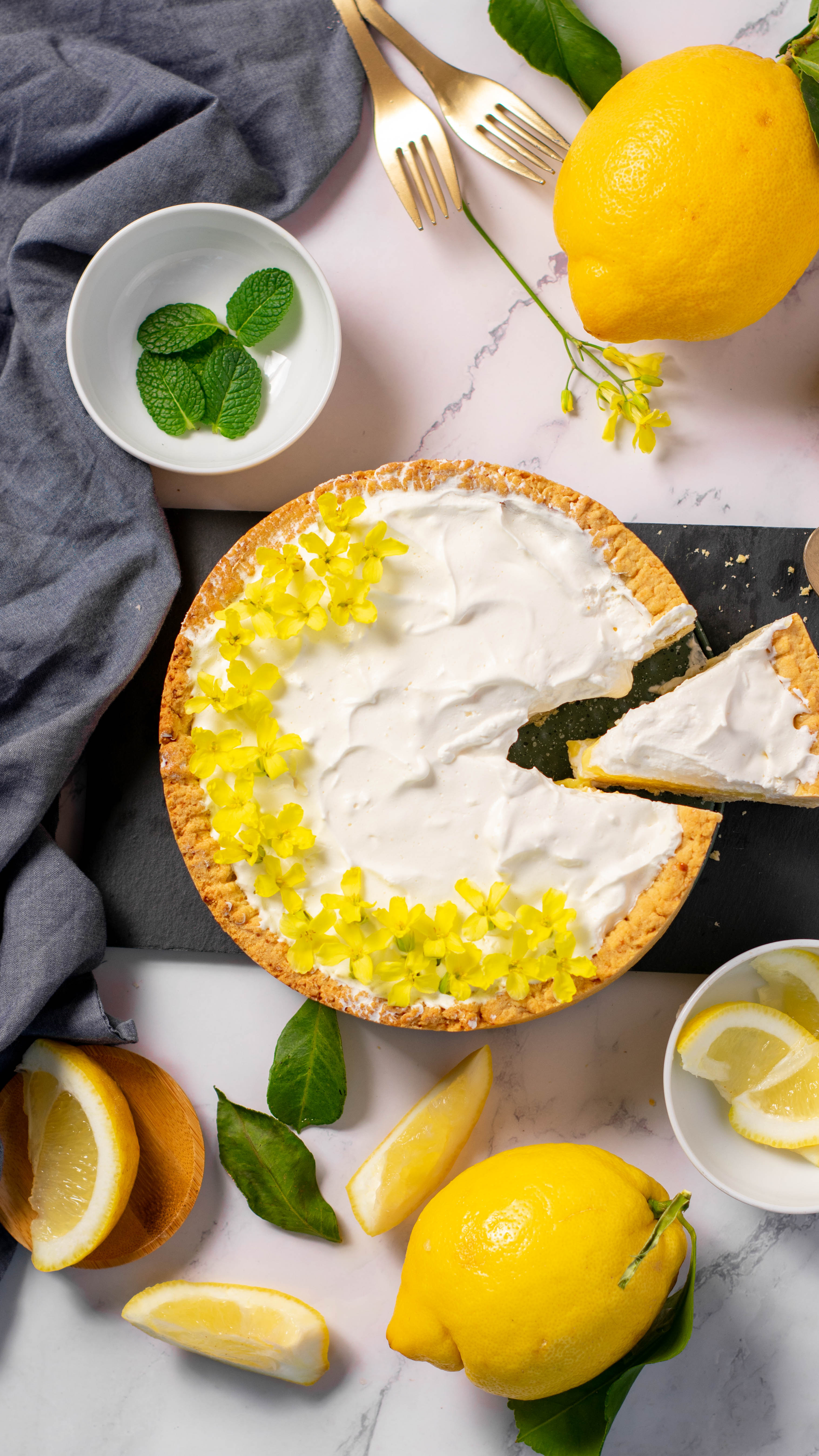 Overhead flat-lay of all ingredients for Italian Limoncello Cheesecake with Mascarpone Cream laid out on a kitchen surface.