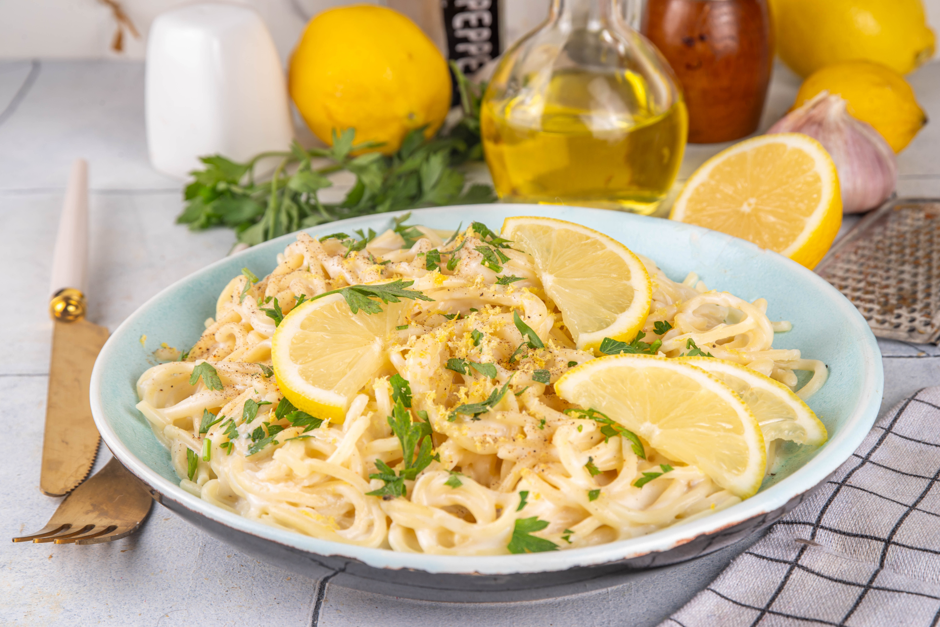 Overhead flat-lay of all ingredients for Italian Pici Pasta with Lemon and Pecorino laid out on a kitchen surface.