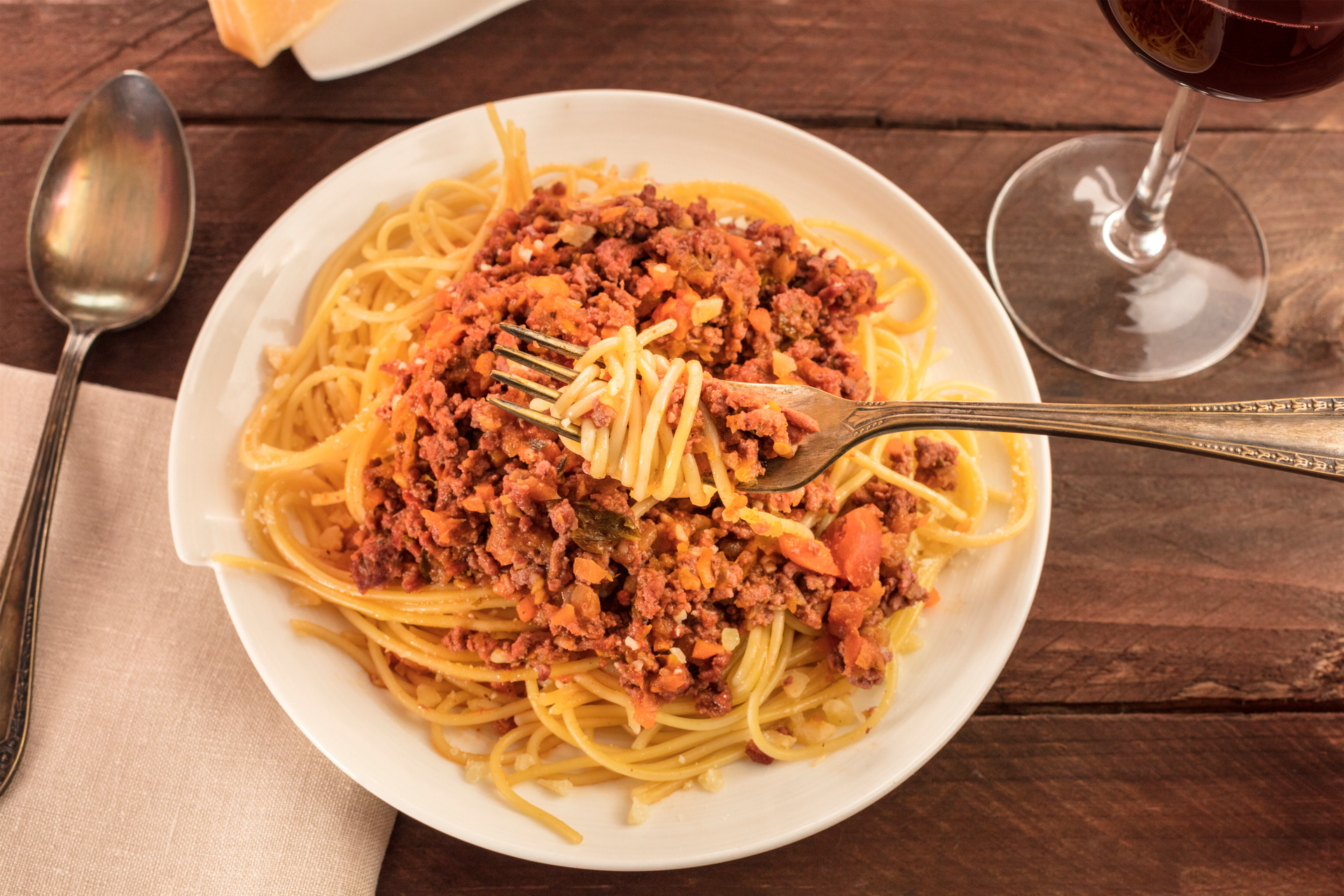 Overhead flat-lay of all ingredients for Italian Pici Pasta with Wild Boar Ragu laid out on a kitchen surface.