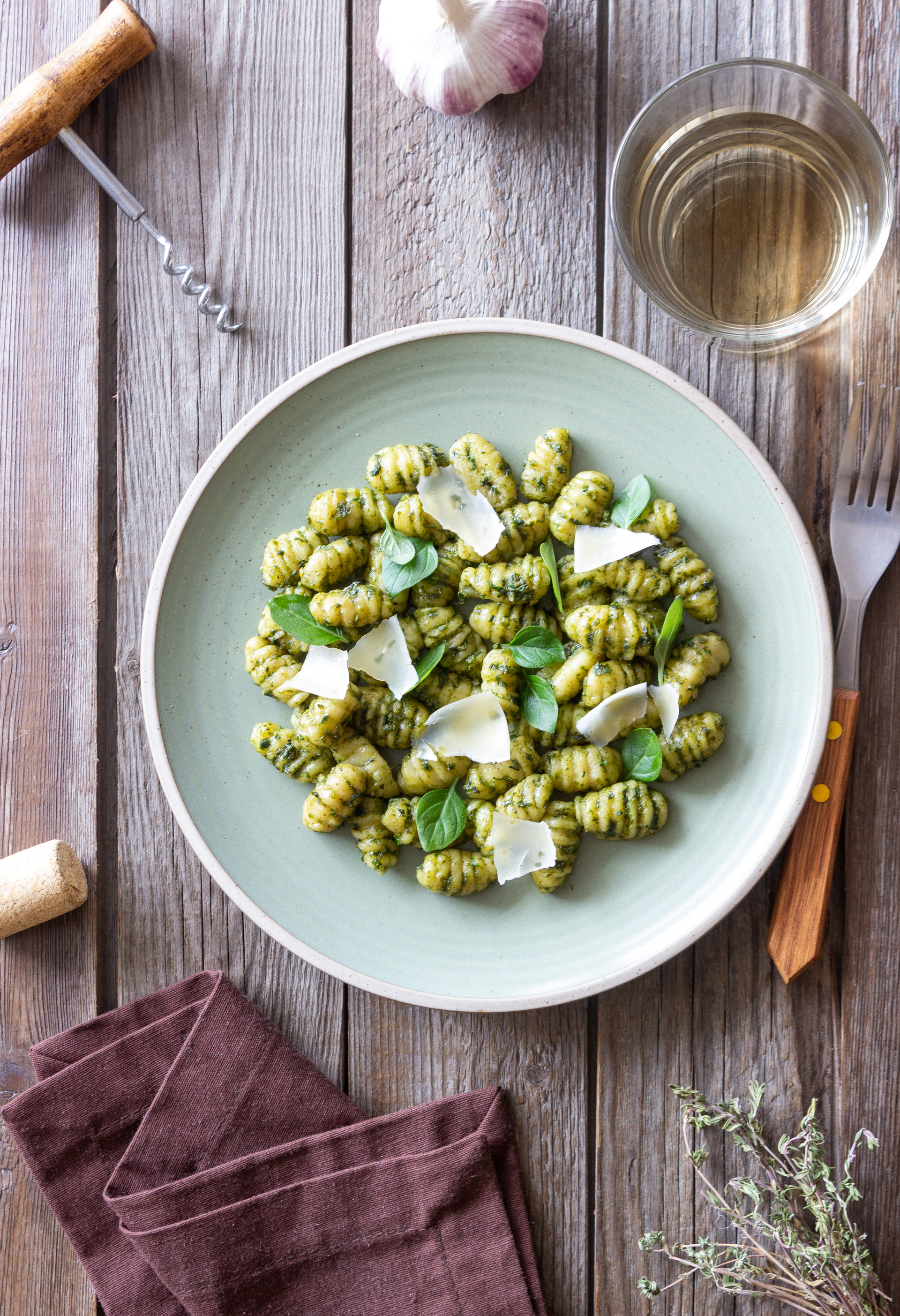 Overhead flat-lay of all ingredients for Italian Ricotta Gnocchi with Sage Butter Sauce and Pine Nuts laid out on a kitchen surface.