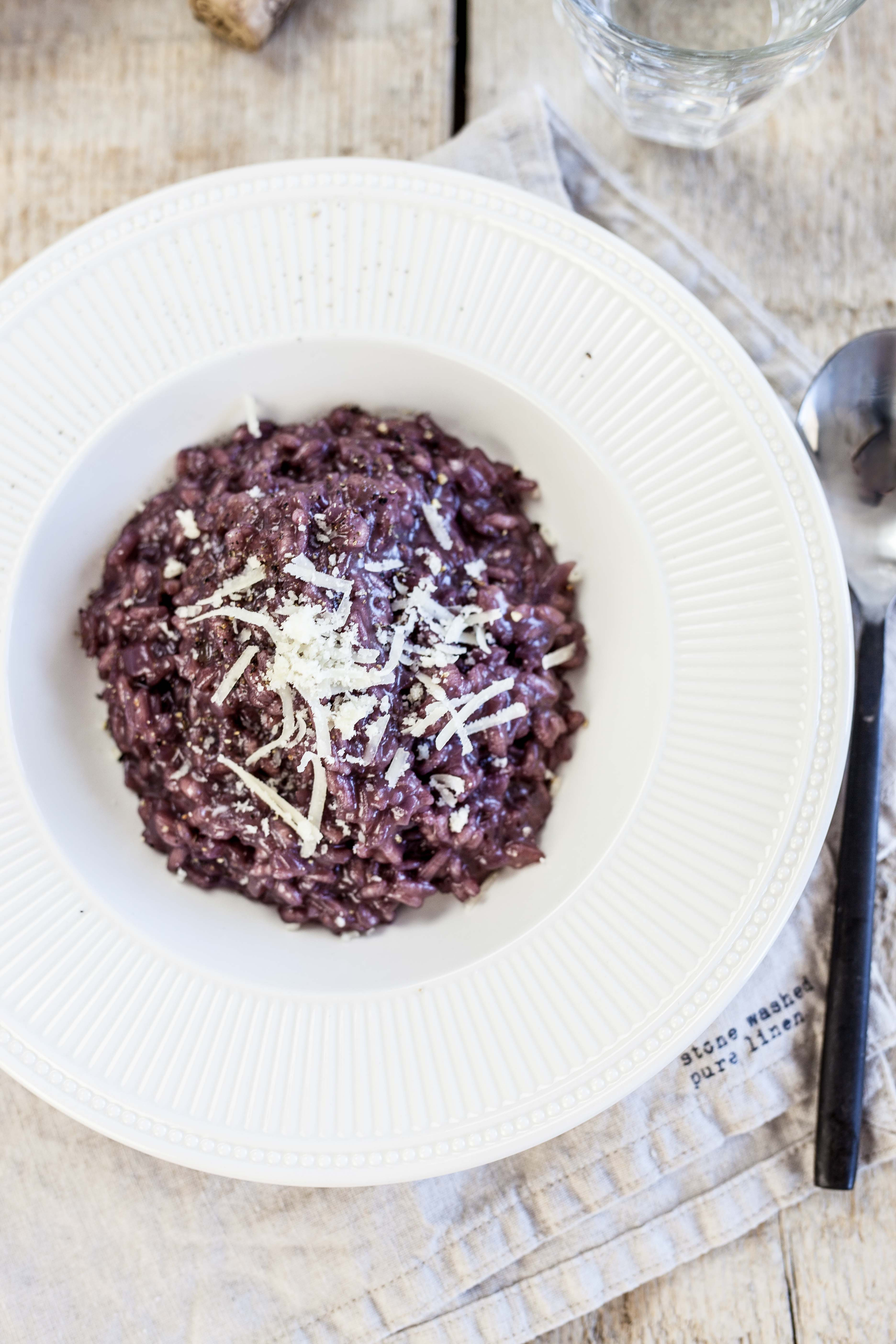 Overhead flat-lay of all ingredients for Italian Risotto al Barolo with Radicchio and Parmesan laid out on a kitchen surface.