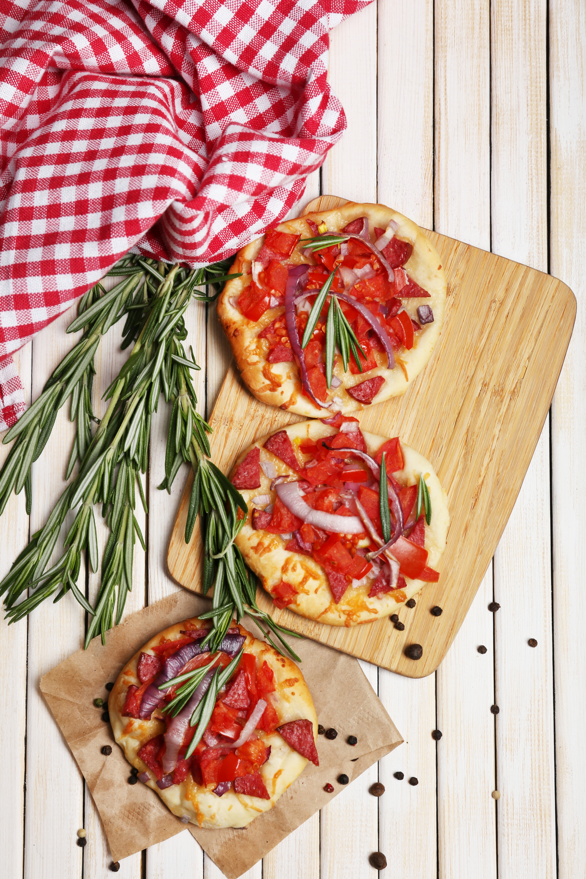 Overhead flat-lay of all ingredients for Italian Rosemary Focaccia with Sundried Tomato and Olive Tapenade laid out on a kitchen surface.
