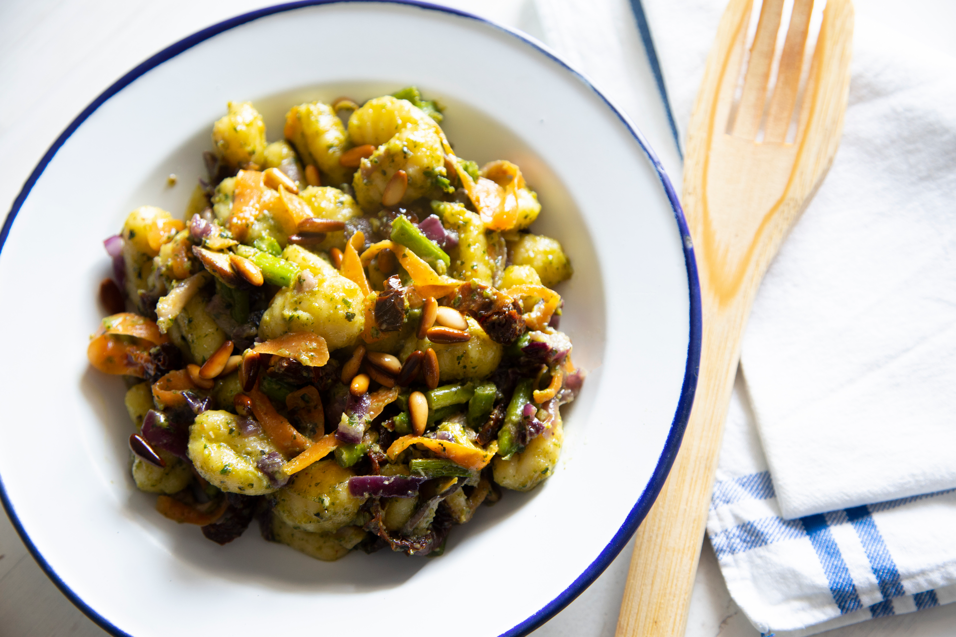 Overhead flat-lay of all ingredients for Italian Scafata with Fava Beans and Artichokes laid out on a kitchen surface.