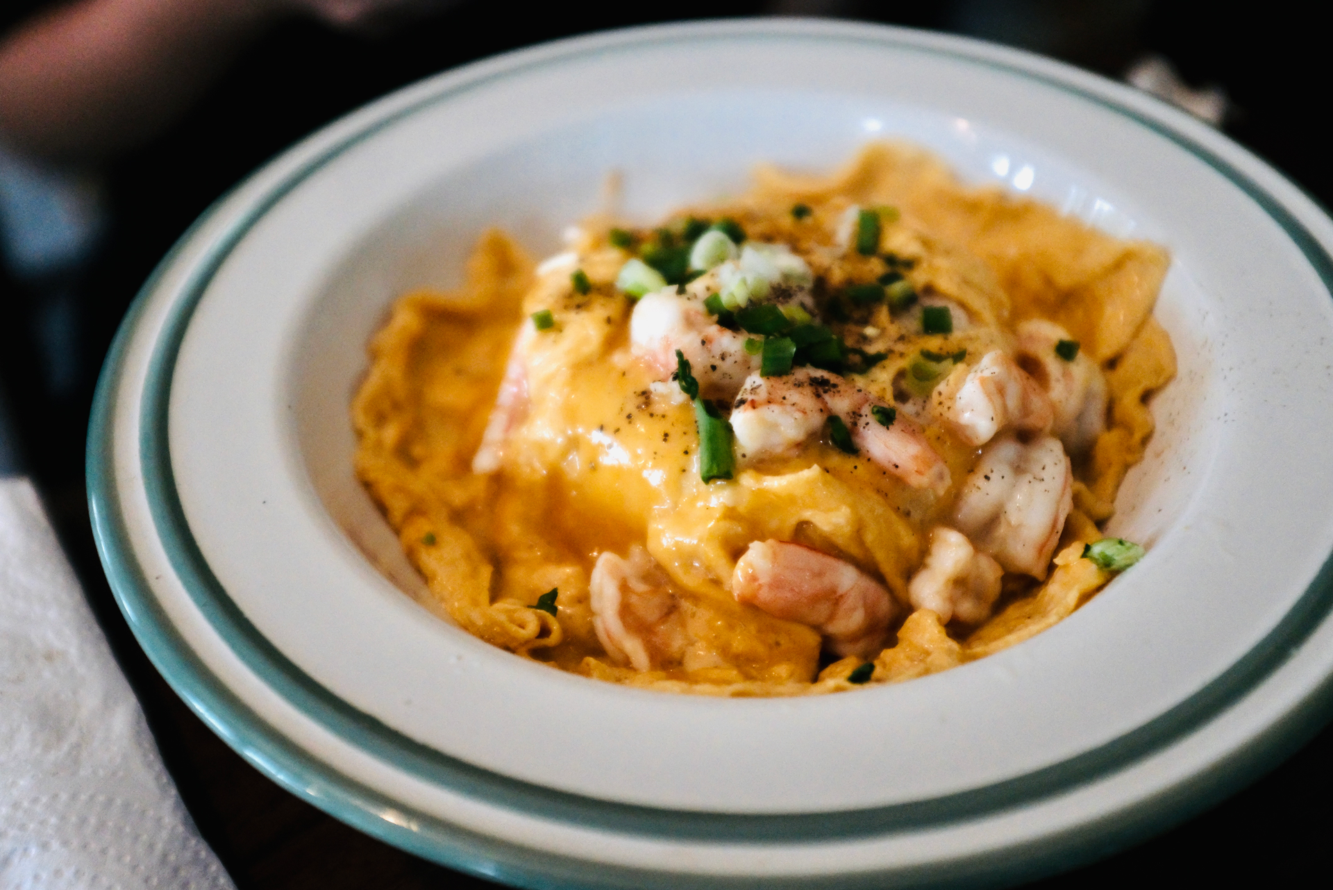 Overhead flat-lay of all ingredients for Italian Sea Urchin Pasta with Garlic and Saffron Cream laid out on a kitchen surface.