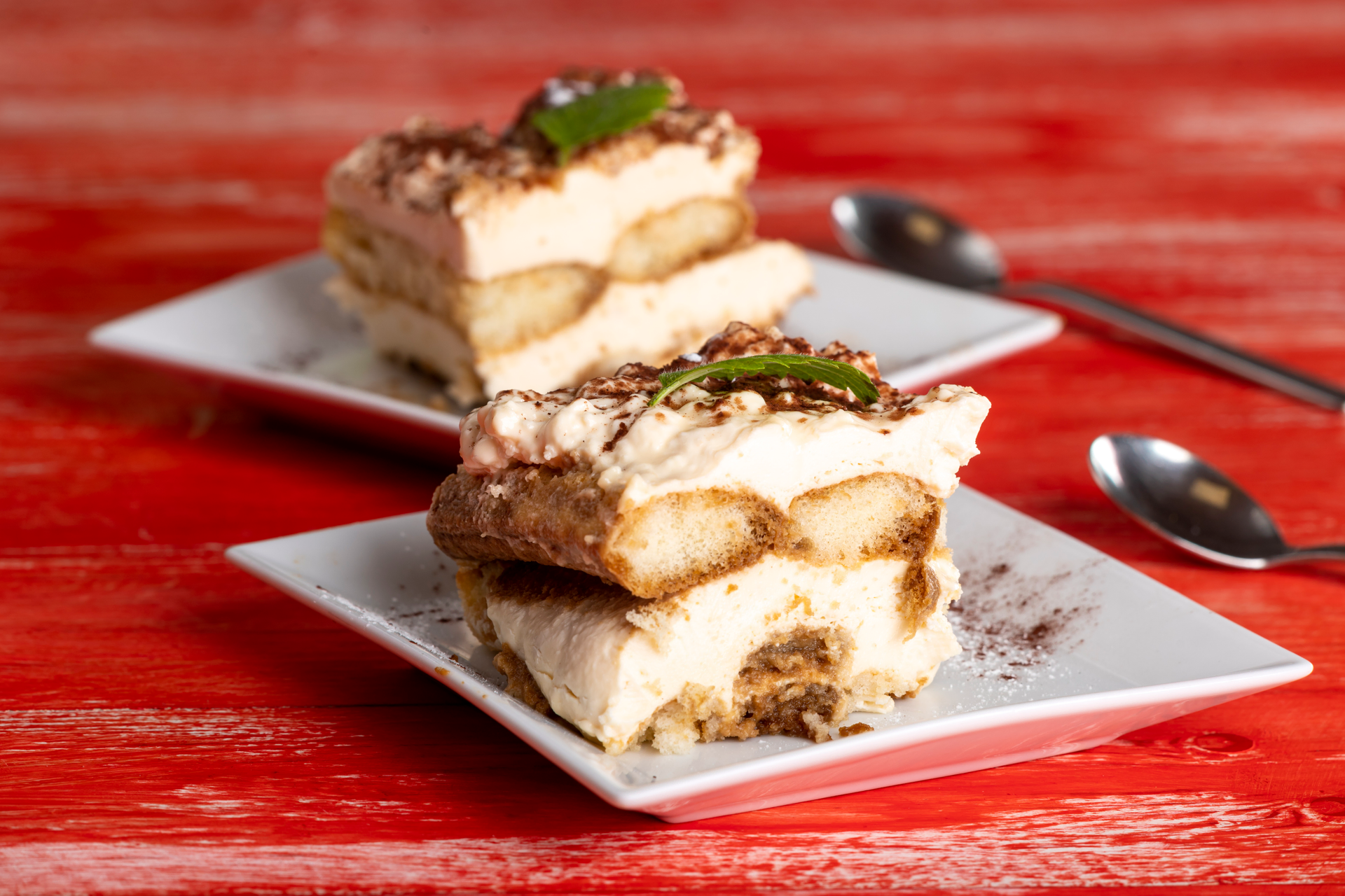 Overhead flat-lay of all ingredients for Italian Tiramisu laid out on a kitchen surface.