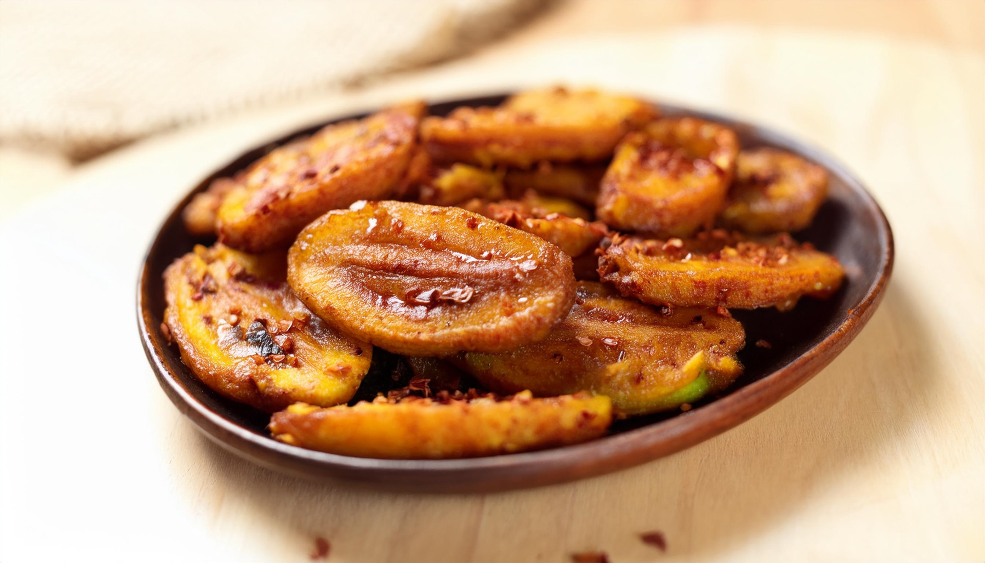 Overhead flat-lay of all ingredients for Ivorian Alloco with Fried Sweet Plantains laid out on a kitchen surface.