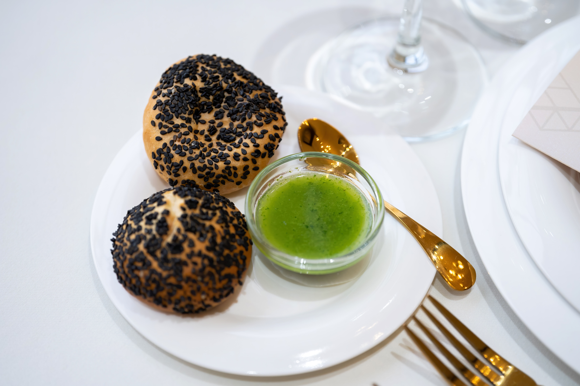 Overhead flat-lay of all ingredients for Japanese Black Sesame Panna Cotta with Matcha Sauce laid out on a kitchen surface.