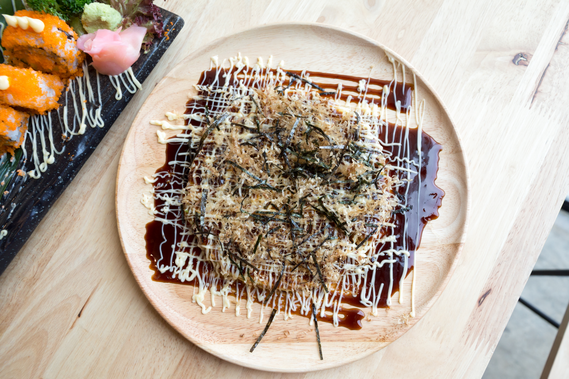 Overhead flat-lay of all ingredients for Japanese Okonomiyaki laid out on a kitchen surface.