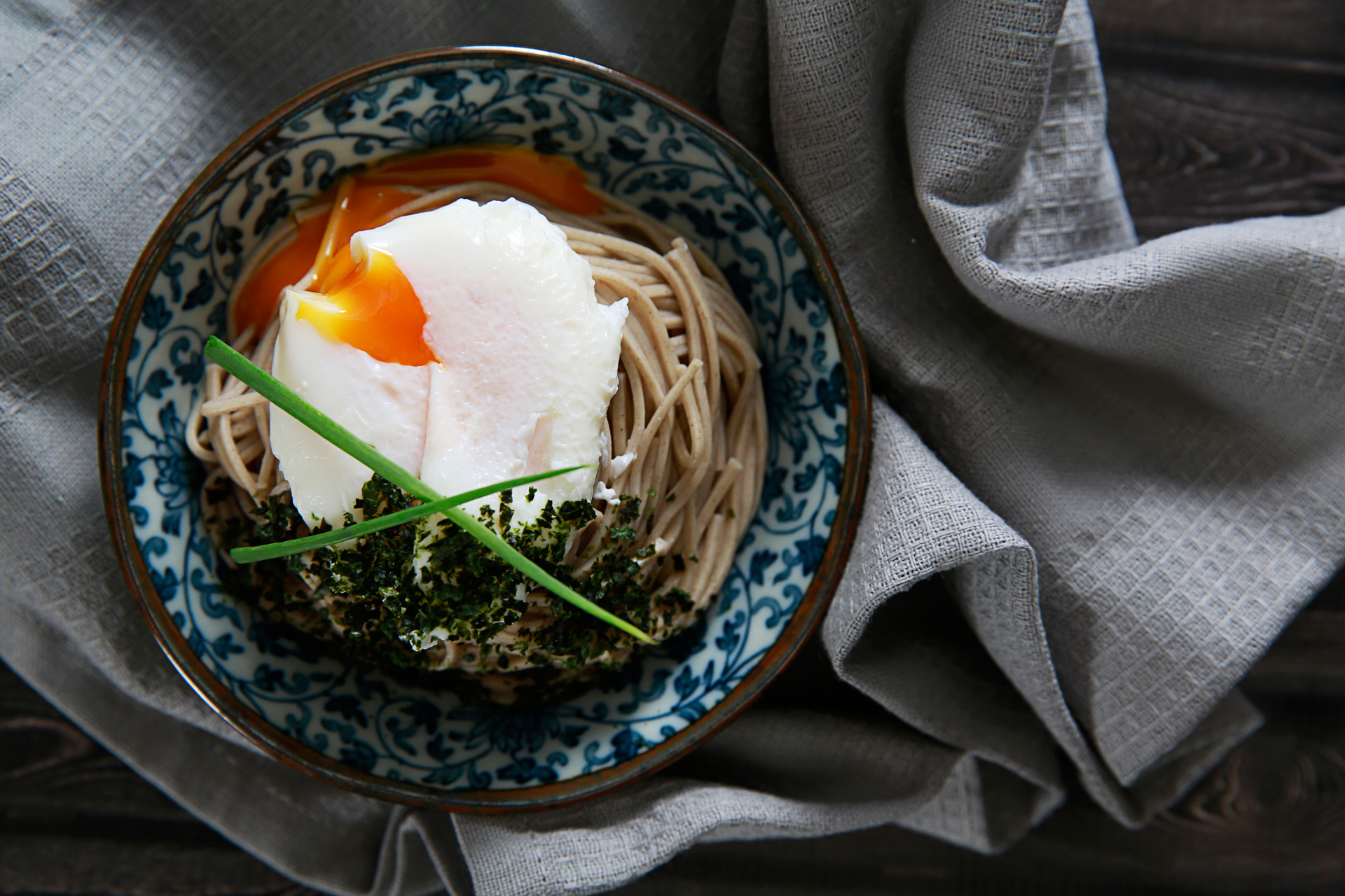 Overhead flat-lay of all ingredients for Japanese Ramen with Chashu and Soft Boiled Egg laid out on a kitchen surface.