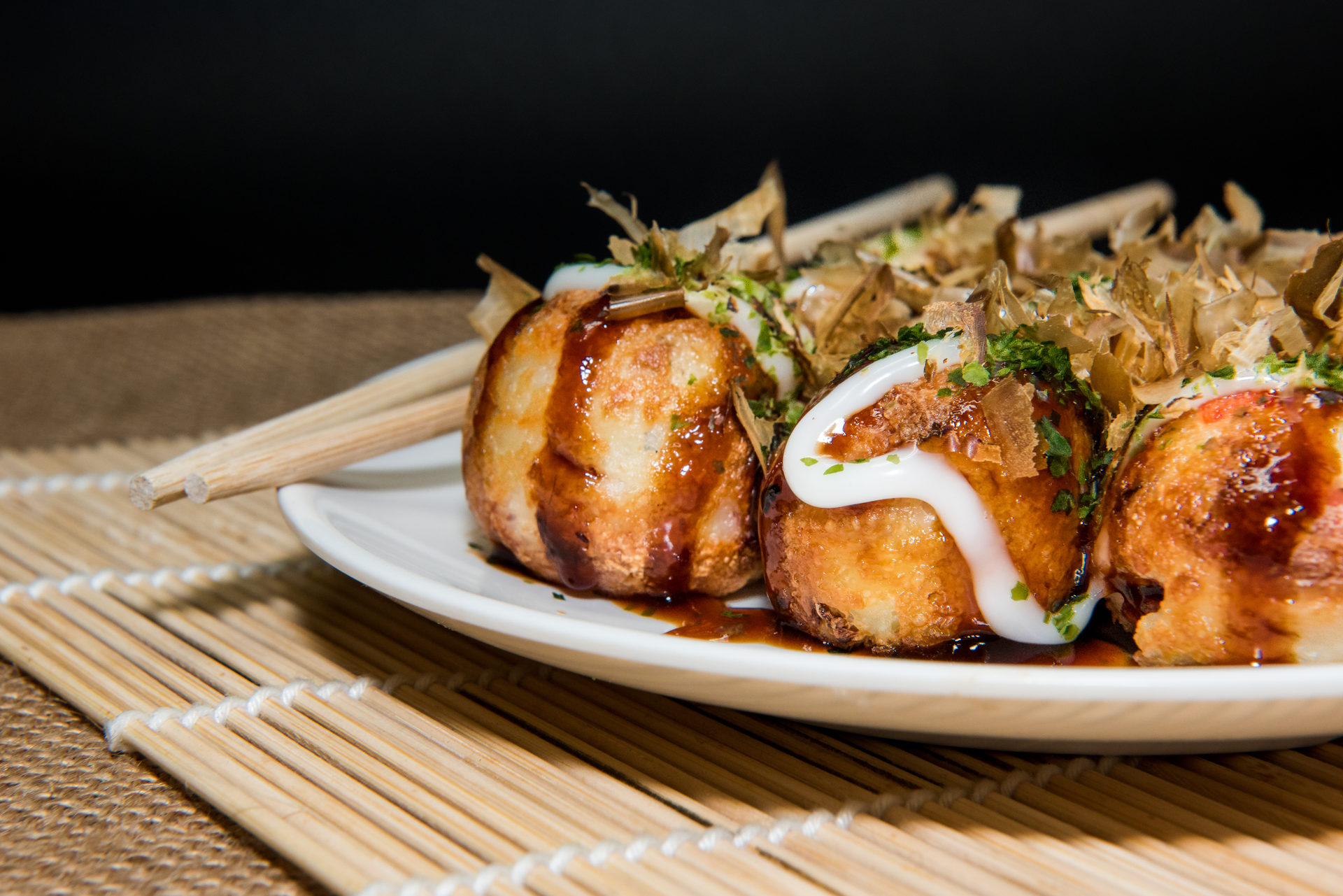 Overhead flat-lay of all ingredients for Japanese Takoyaki with Pickled Ginger and Bonito Flakes laid out on a kitchen surface.