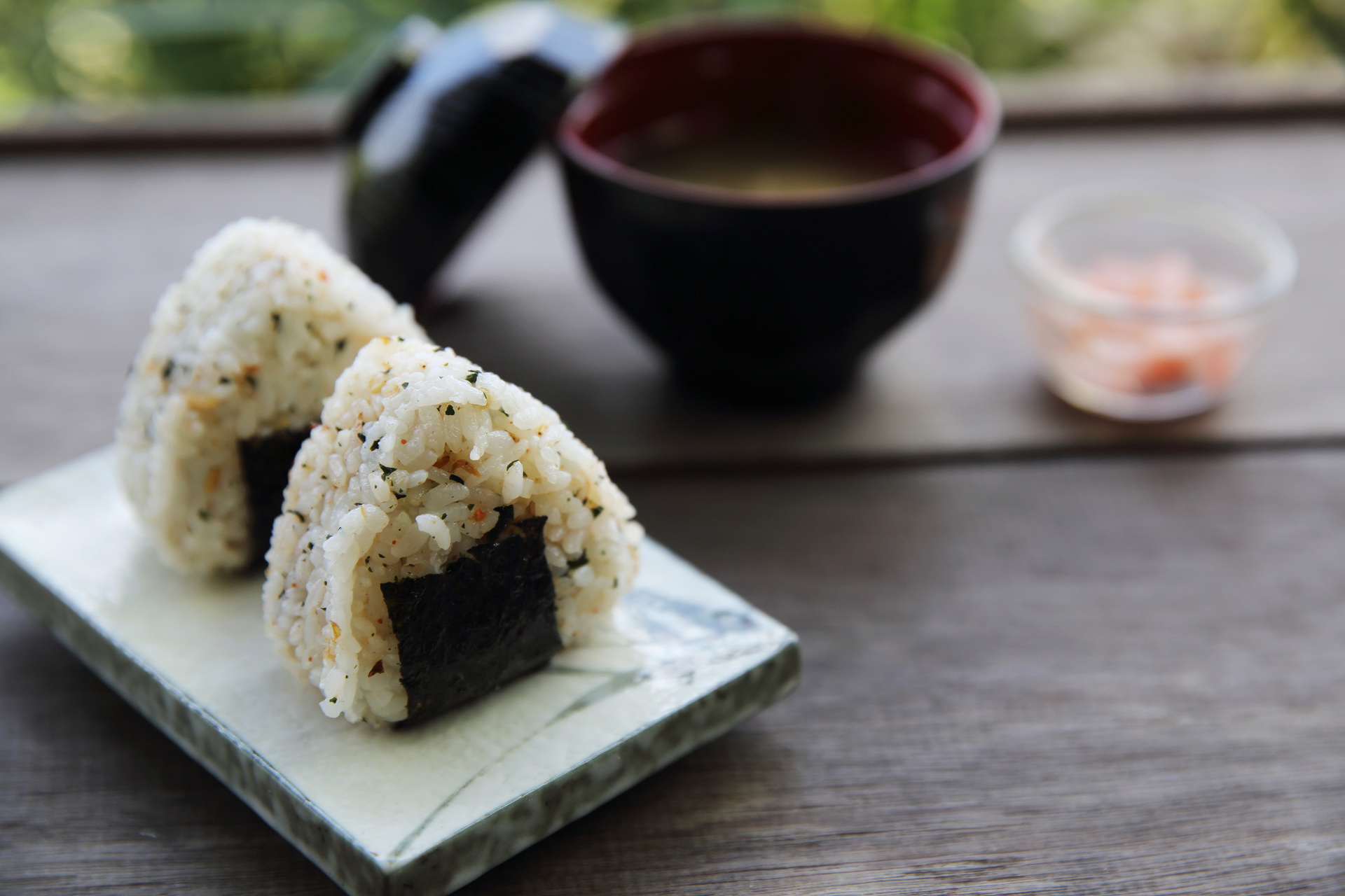 Overhead flat-lay of all ingredients for Japanese Yaki Onigiri with Soy Glaze and Nori Garnish laid out on a kitchen surface.
