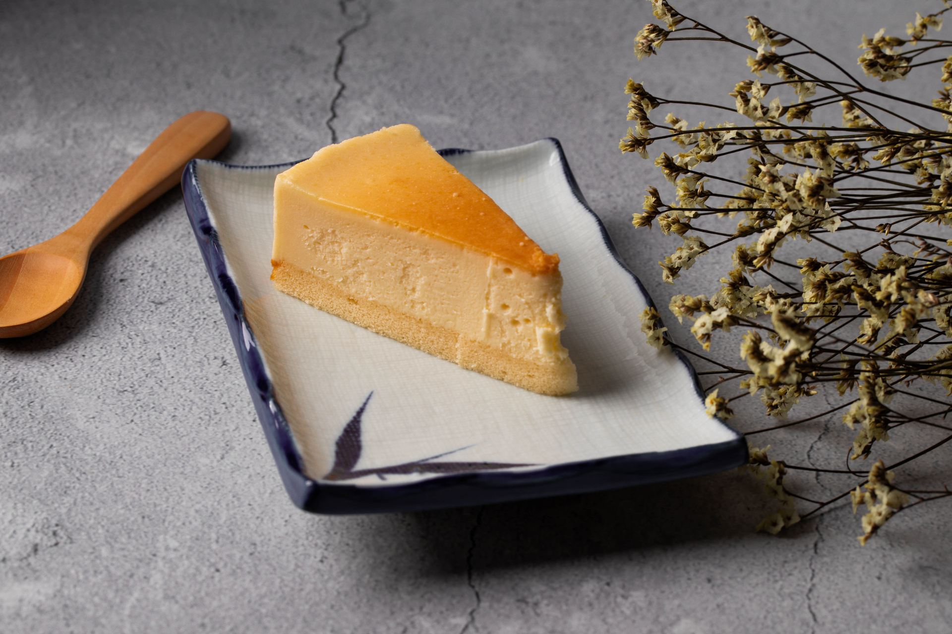 Overhead flat-lay of all ingredients for Japanese Yuzu Cheesecake with Kinako Crumble laid out on a kitchen surface.