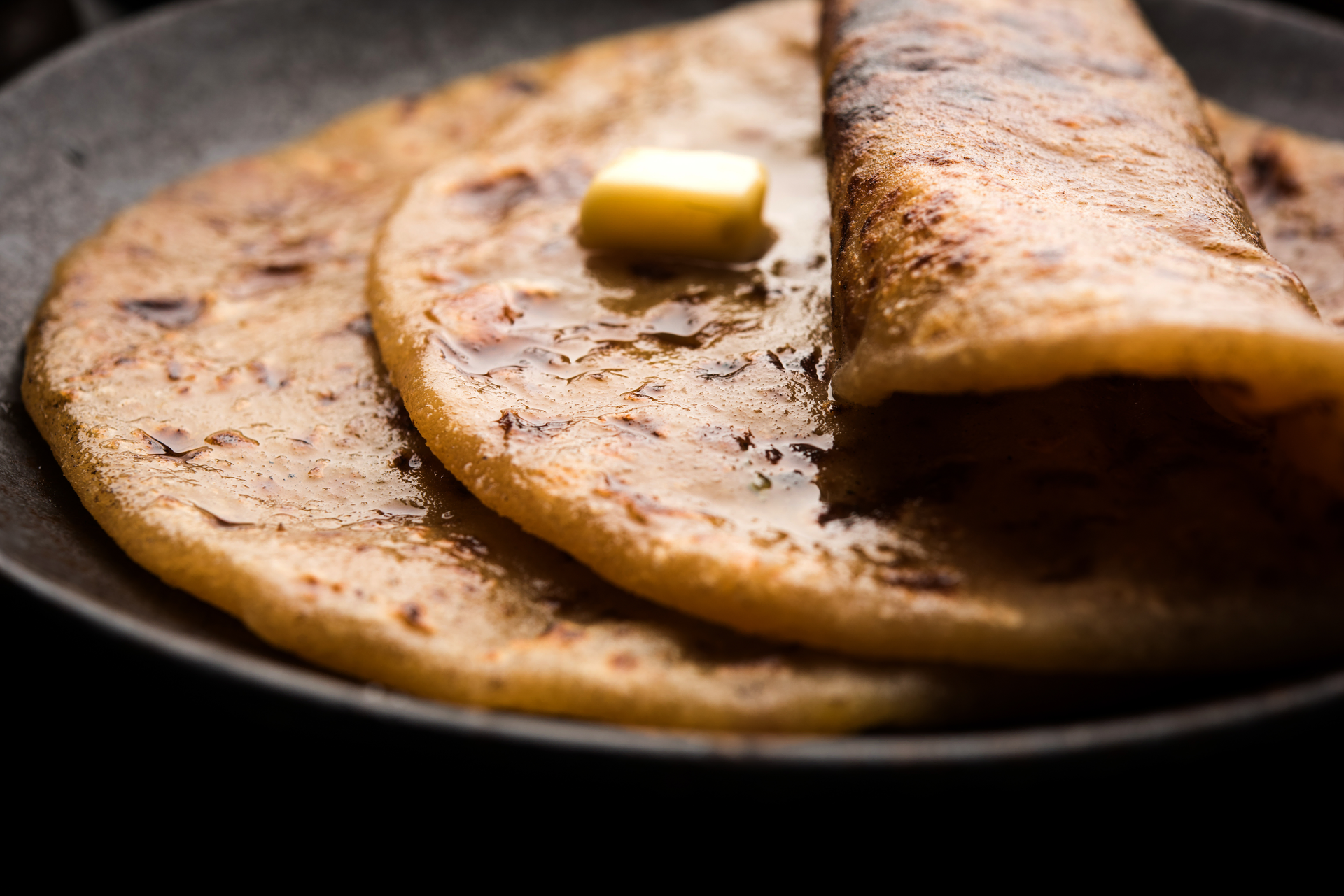Overhead flat-lay of all ingredients for Kenyan Chapati with Cinnamon and Cardamom laid out on a kitchen surface.