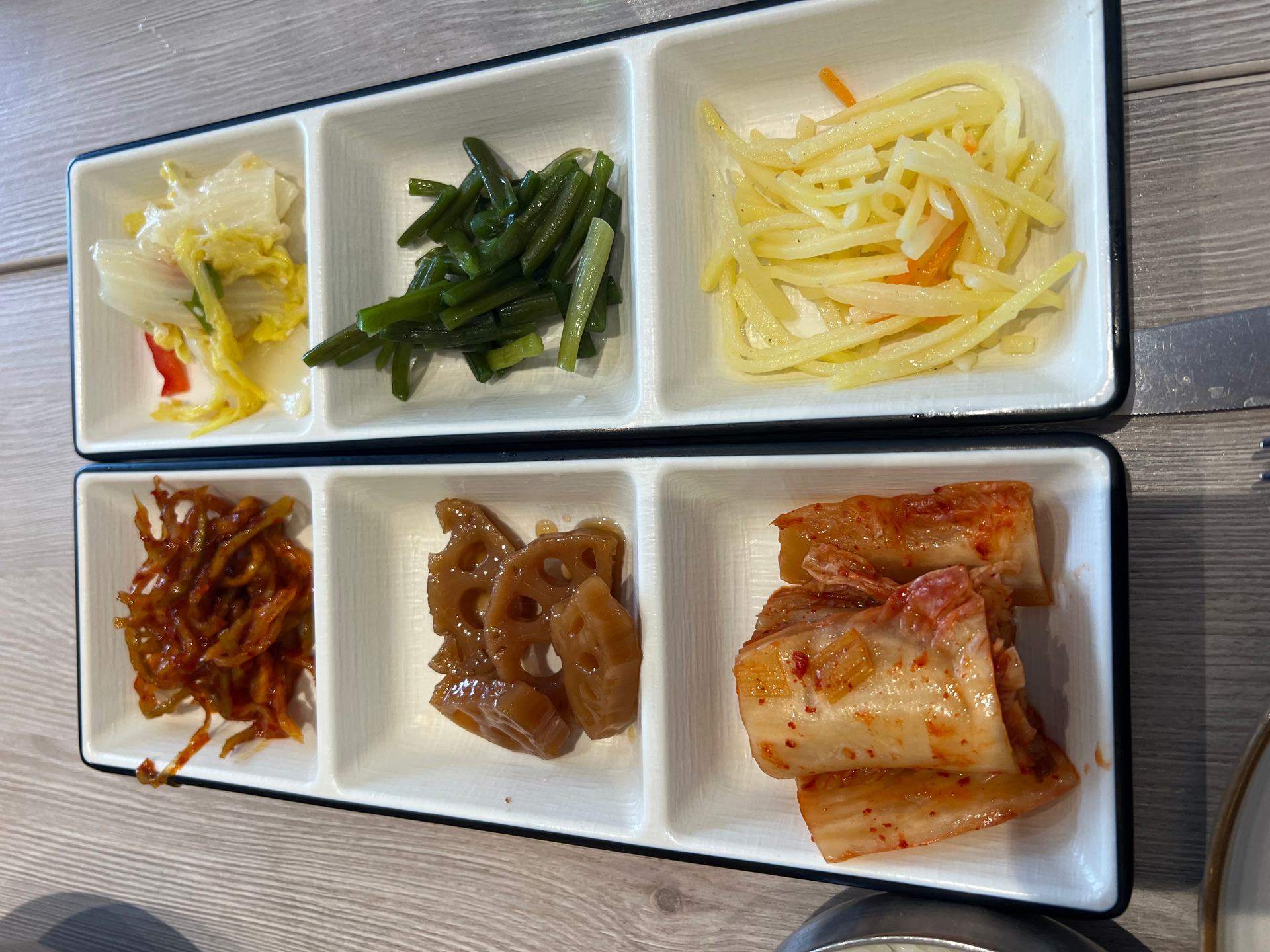 Overhead flat-lay of all ingredients for Korean Banchan Assortment with Fermented Vegetables laid out on a kitchen surface.