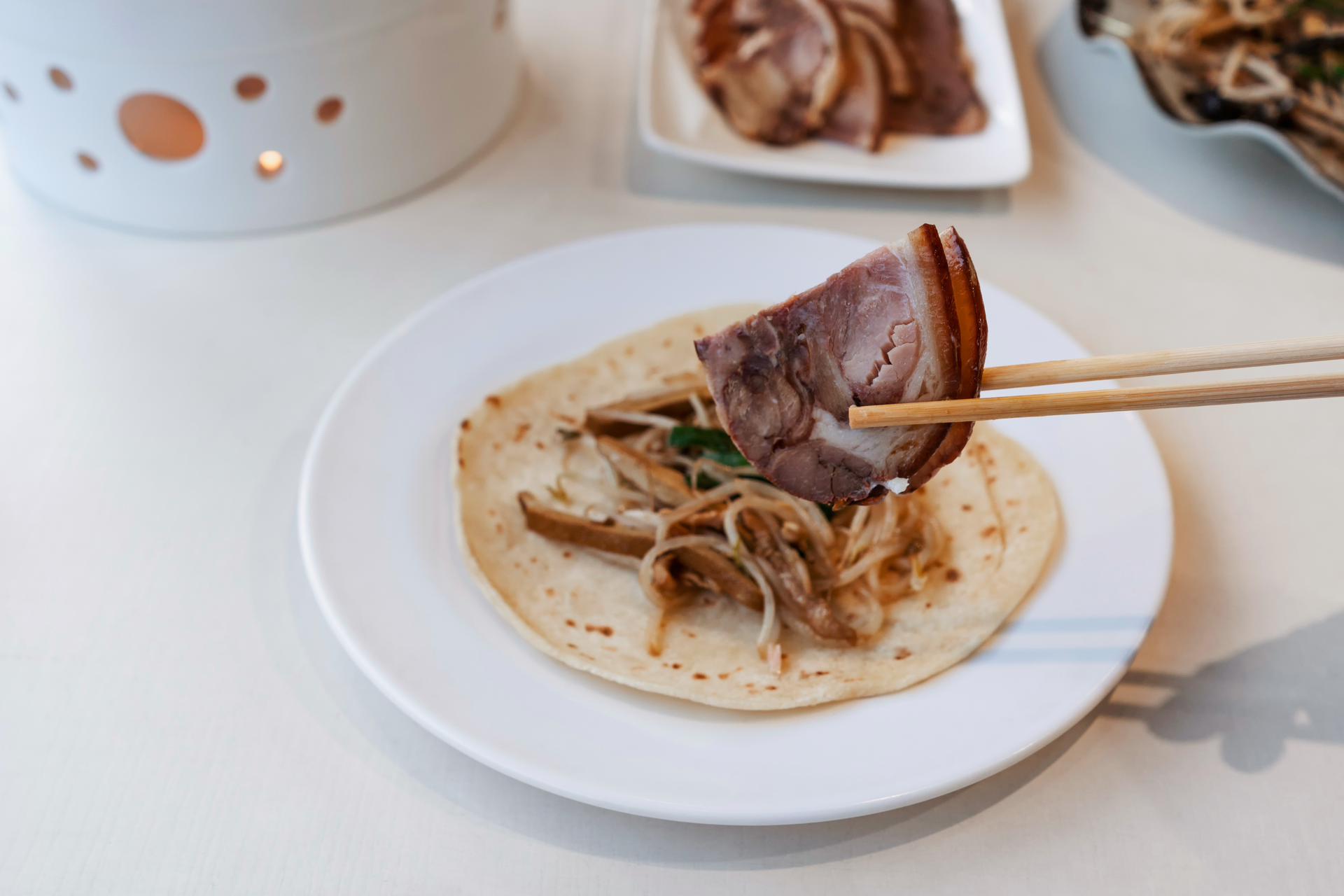 Overhead flat-lay of all ingredients for Korean Bulgogi Beef Wraps with Sesame Seeds laid out on a kitchen surface.