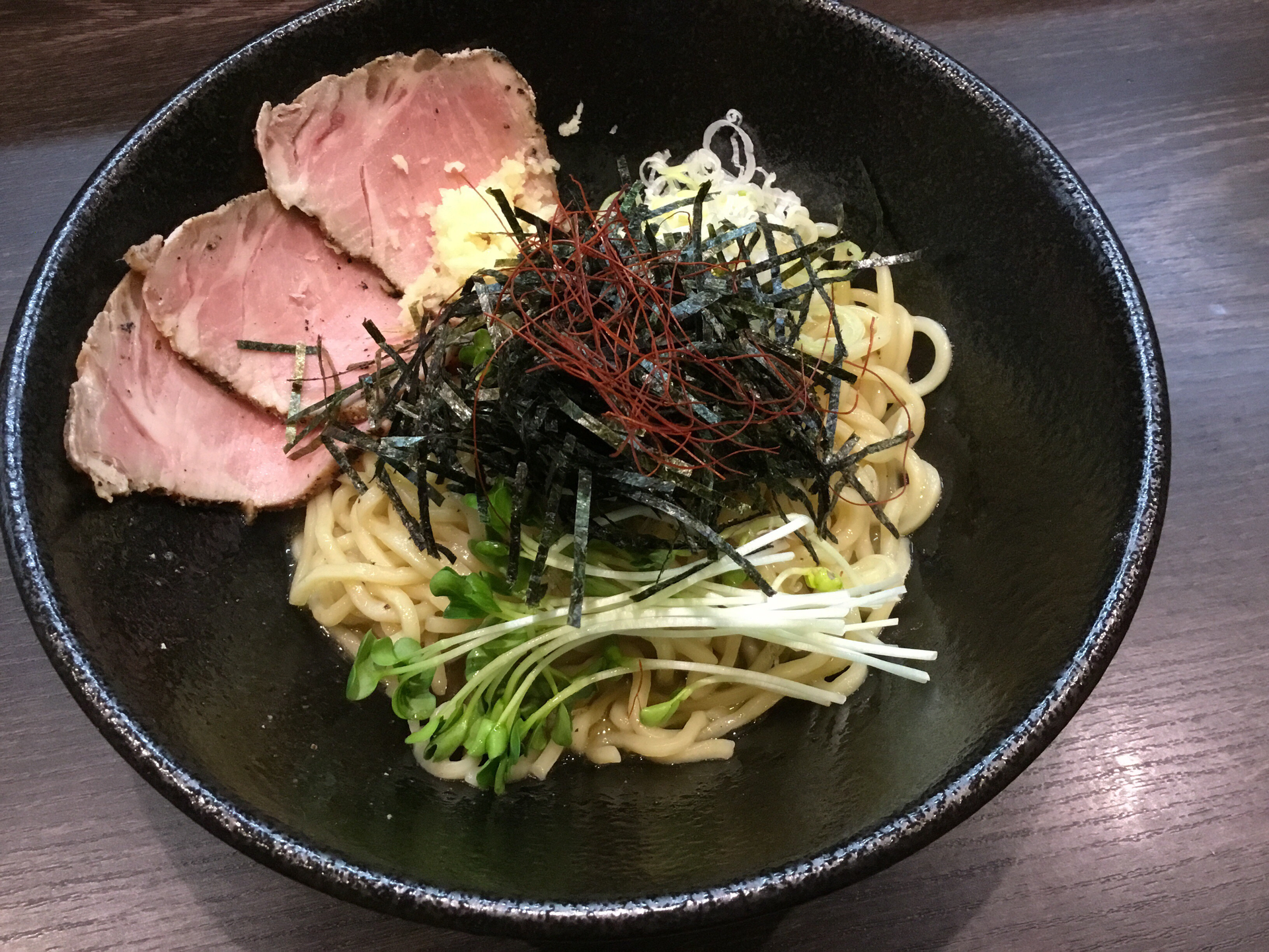 Overhead flat-lay of all ingredients for Korean Japchae Noodles with Spinach and Beef laid out on a kitchen surface.