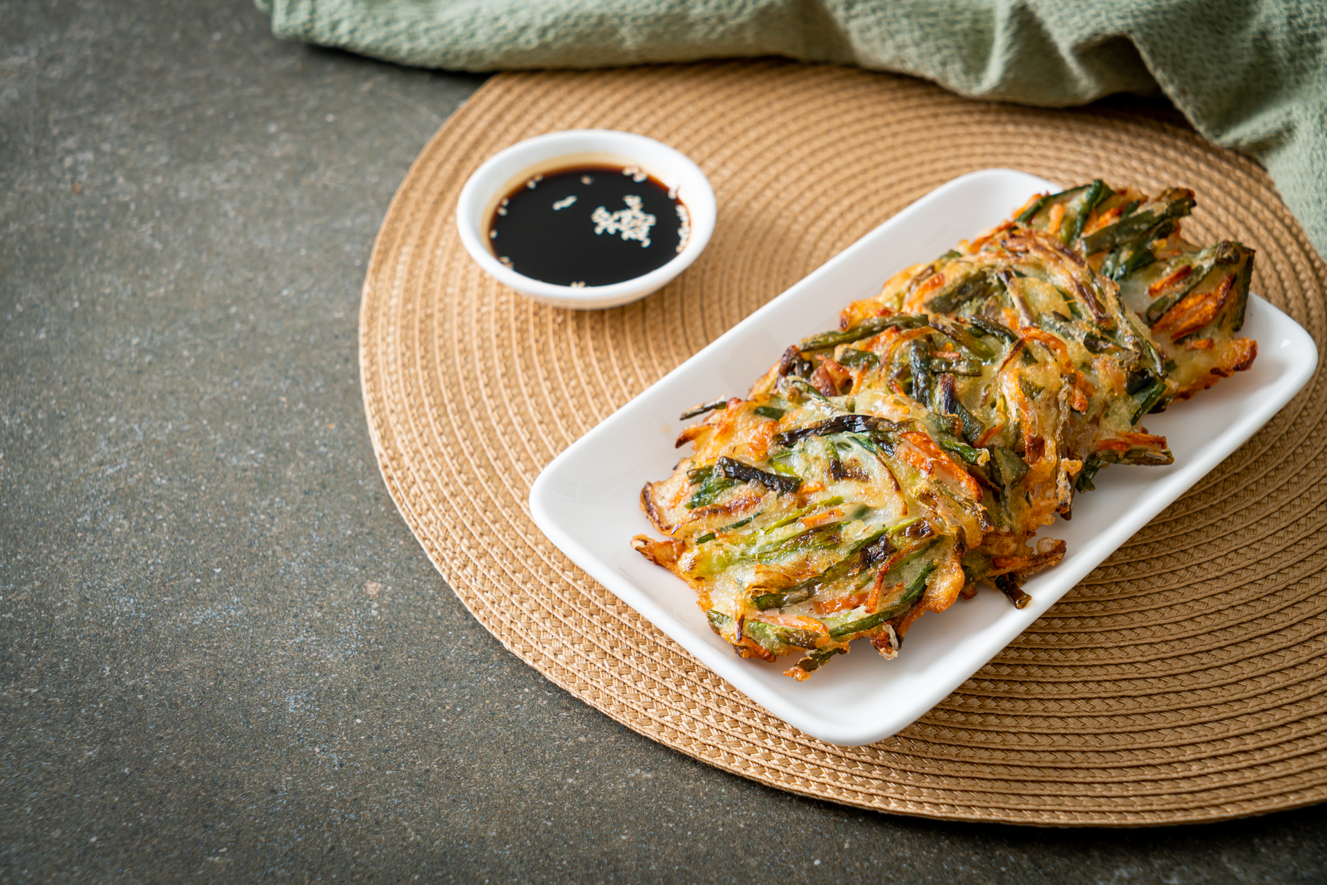 Overhead flat-lay of all ingredients for Korean Japchae Spring Rolls with Sesame Dip and Peanut Sauce laid out on a kitchen surface.