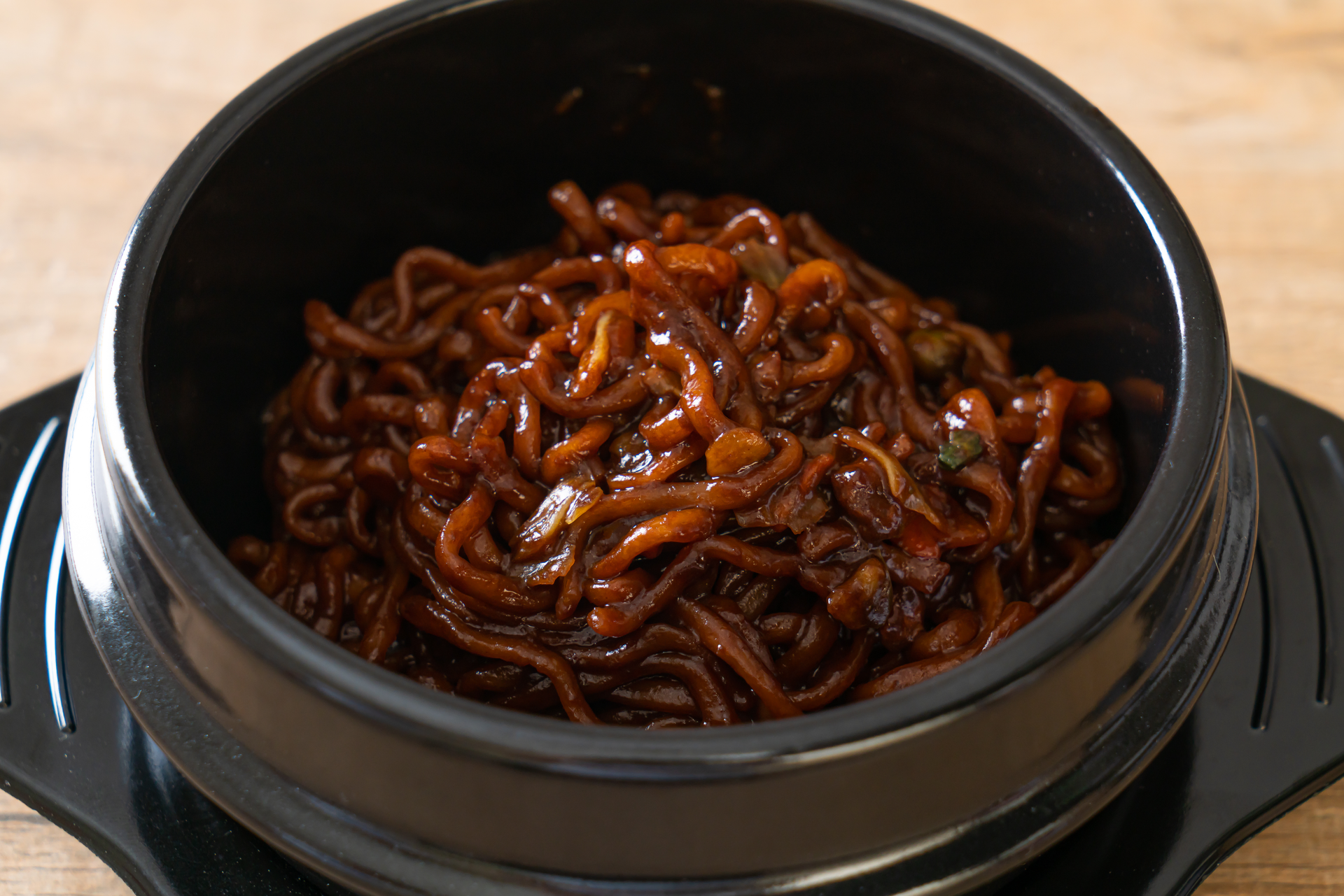 Overhead flat-lay of all ingredients for Korean Jjajangmyeon with Black Bean Sauce and Pork laid out on a kitchen surface.