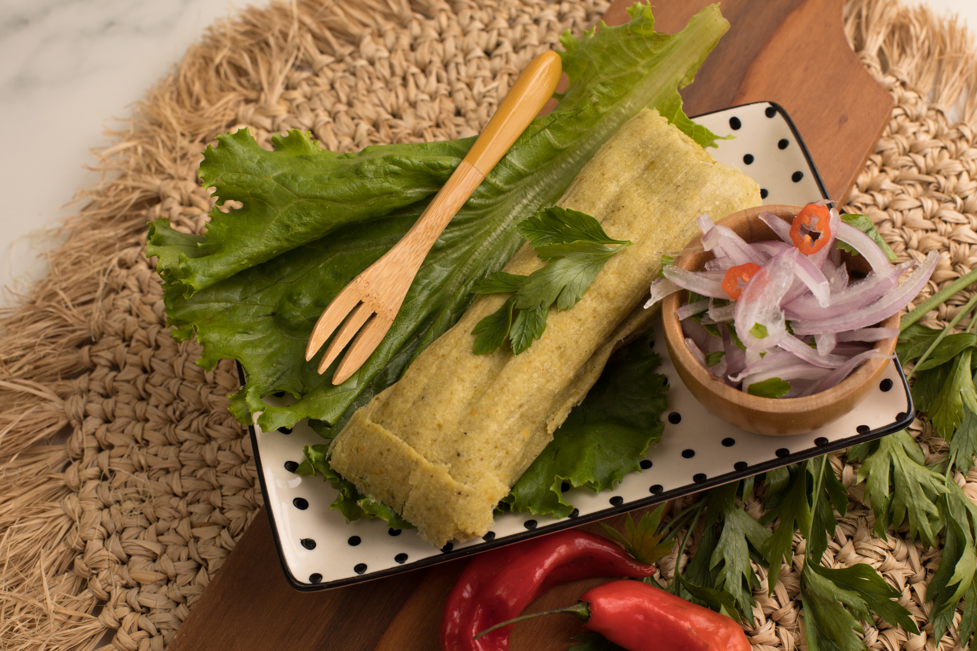 Lao Crispy Coconut Pancakes with Turmeric Leaf Wrapping — Appetizer served and photographed from above