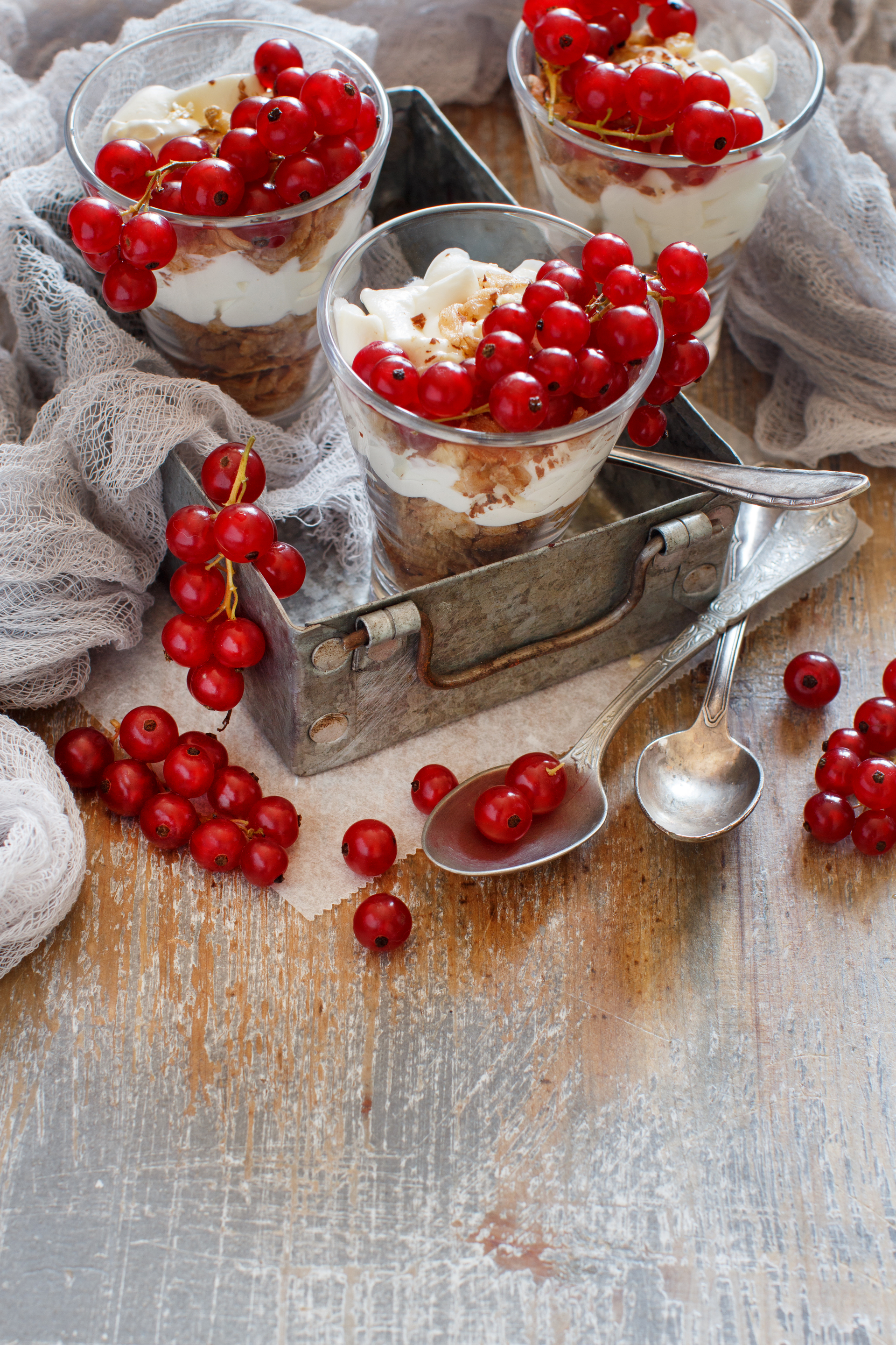Overhead flat-lay of all ingredients for Latvian Rye Bread Pudding with Cranberries and Cream laid out on a kitchen surface.