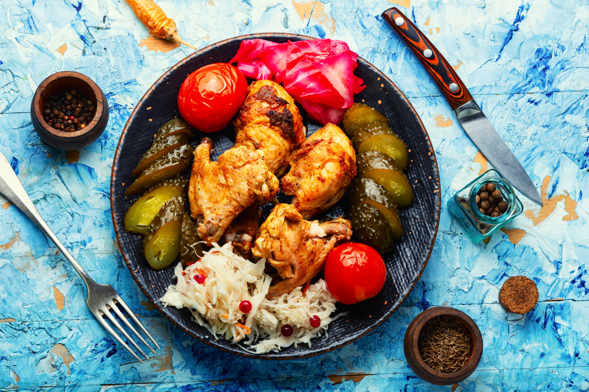 Overhead flat-lay of all ingredients for Lebanese Chicken Moghrabieh with Spiced Couscous laid out on a kitchen surface.