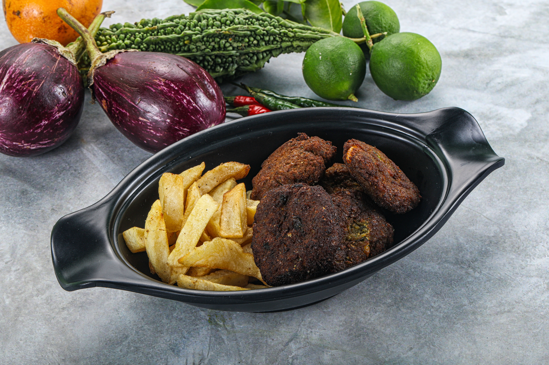 Overhead flat-lay of all ingredients for Lebanese Kafta Bil Sanieh with Tomato and Potato Layers laid out on a kitchen surface.