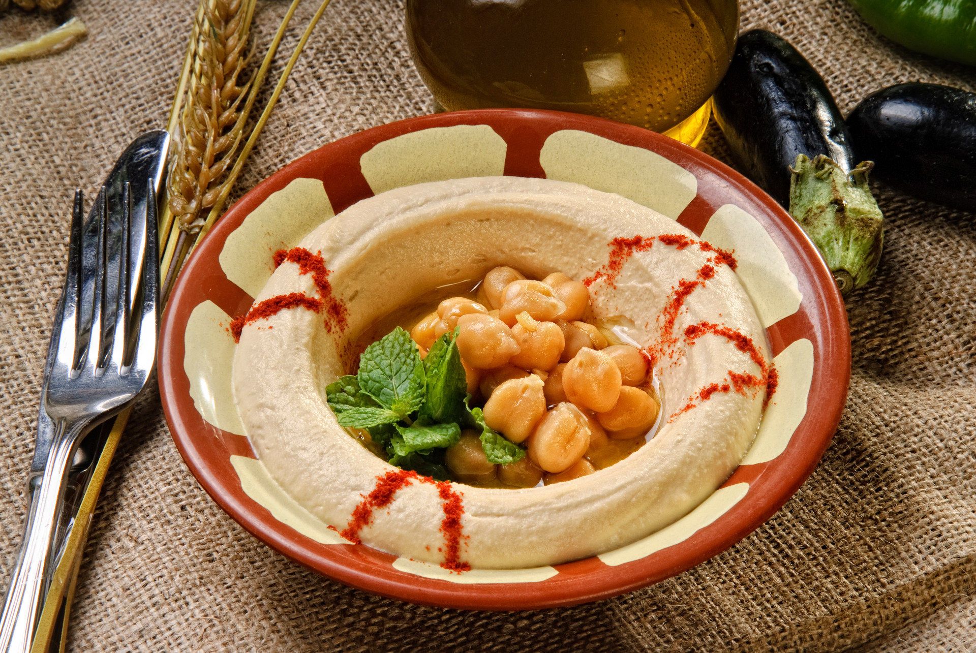 Overhead flat-lay of all ingredients for Lebanese Moghrabieh with Chicken and Chickpeas laid out on a kitchen surface.