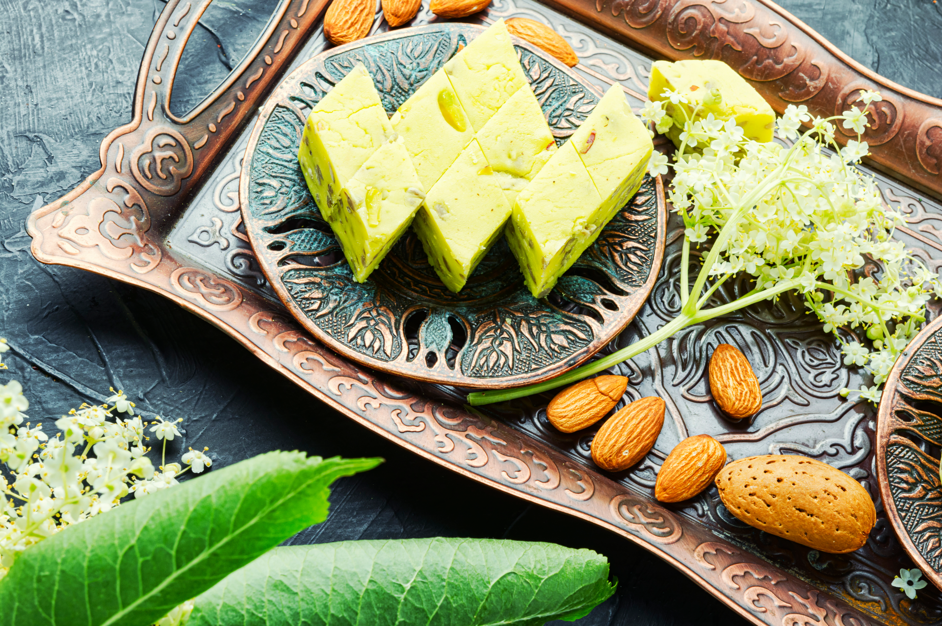Overhead flat-lay of all ingredients for Lebanese Pistachio and Rosewater Cake with Lemon Syrup laid out on a kitchen surface.