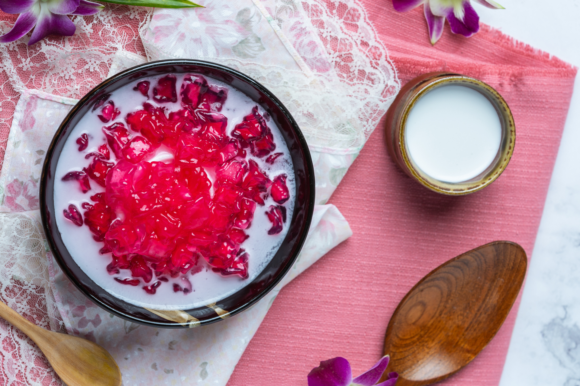 Overhead flat-lay of all ingredients for Lebanese Rose Water Rice Pudding with Loukoum laid out on a kitchen surface.