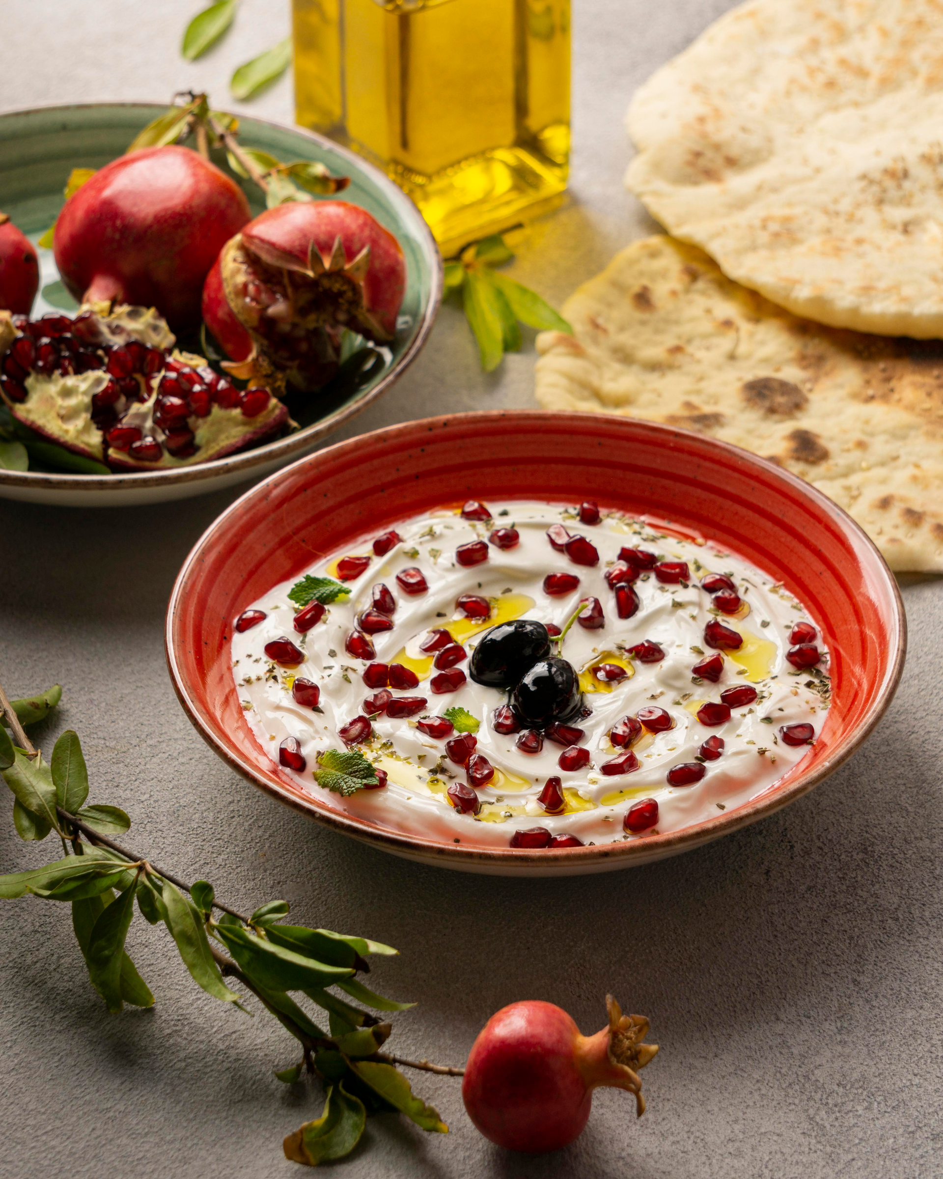Overhead flat-lay of all ingredients for Lebanese Spicy Sumac-Kissed Hummus with Pomegranate Seeds laid out on a kitchen surface.