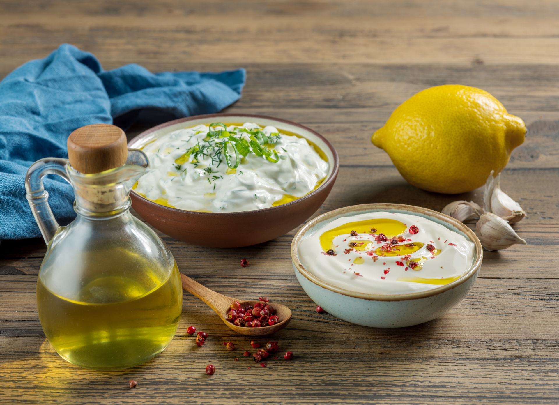 Overhead flat-lay of all ingredients for Lebanese Toum Sauce with Fresh Garlic and Lemon laid out on a kitchen surface.
