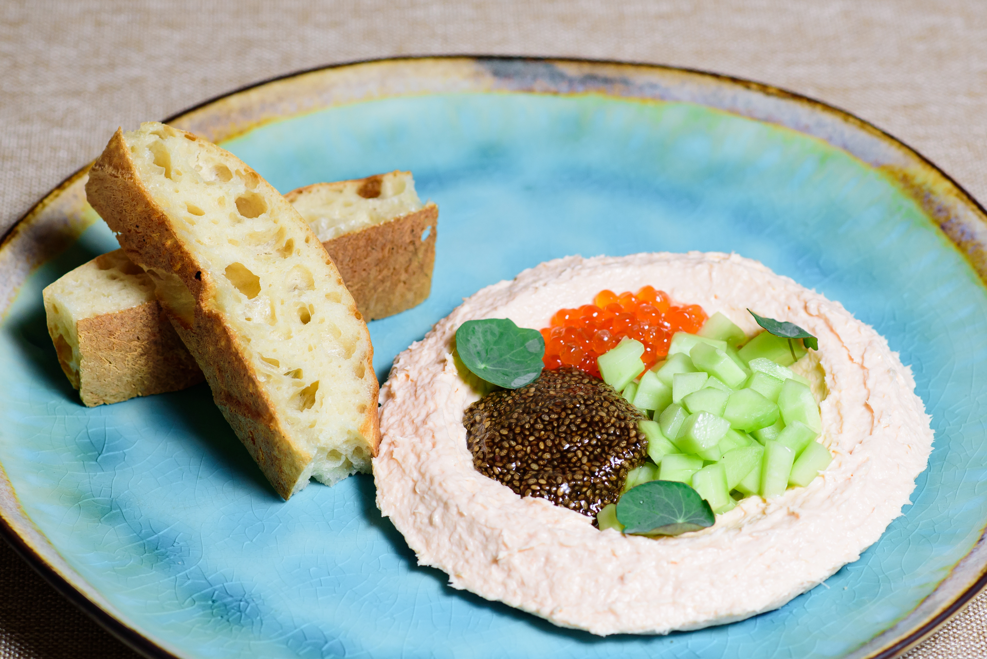 Overhead flat-lay of all ingredients for Lemon-Infused Baltic Herring Tartare with Rye Crumble laid out on a kitchen surface.