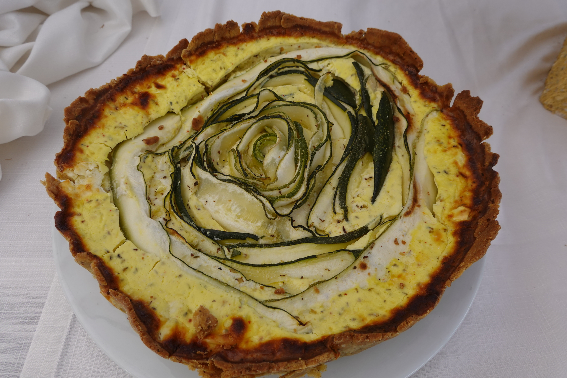 Overhead flat-lay of all ingredients for Lemony Mediterranean Artichoke and Olive Tart laid out on a kitchen surface.