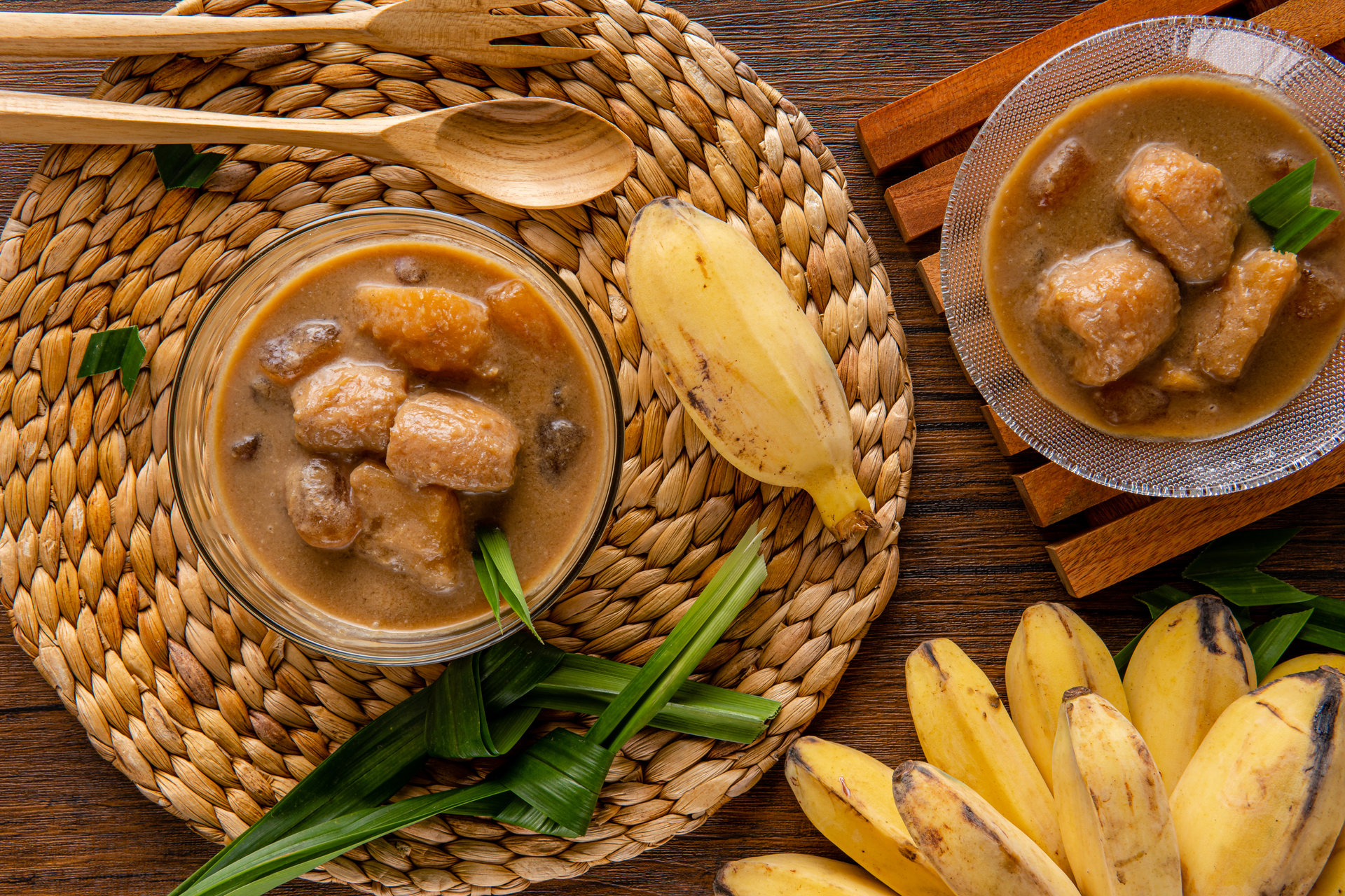 Overhead flat-lay of all ingredients for Luscious Indonesian Kolak Pisang with Coconut and Palm Sugar laid out on a kitchen surface.