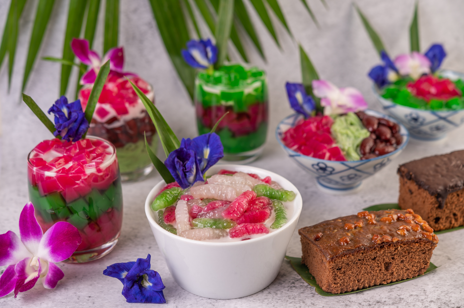 Overhead flat-lay of all ingredients for Luscious Philippine Halo-Halo with Fruity Condiments laid out on a kitchen surface.