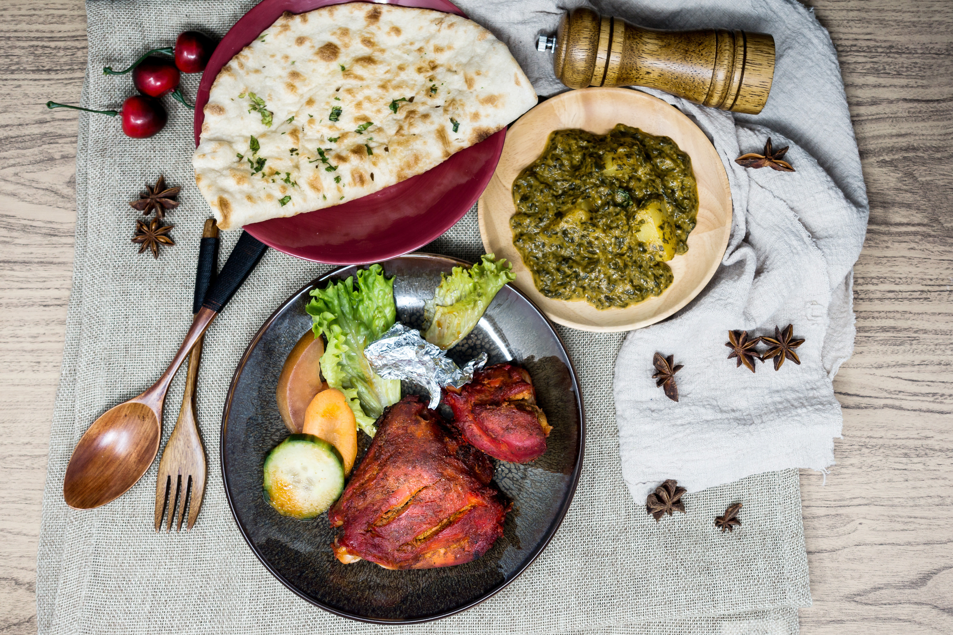 Overhead flat-lay of all ingredients for Lush Yemeni Saltah with Lamb and Fenugreek Sauce laid out on a kitchen surface.