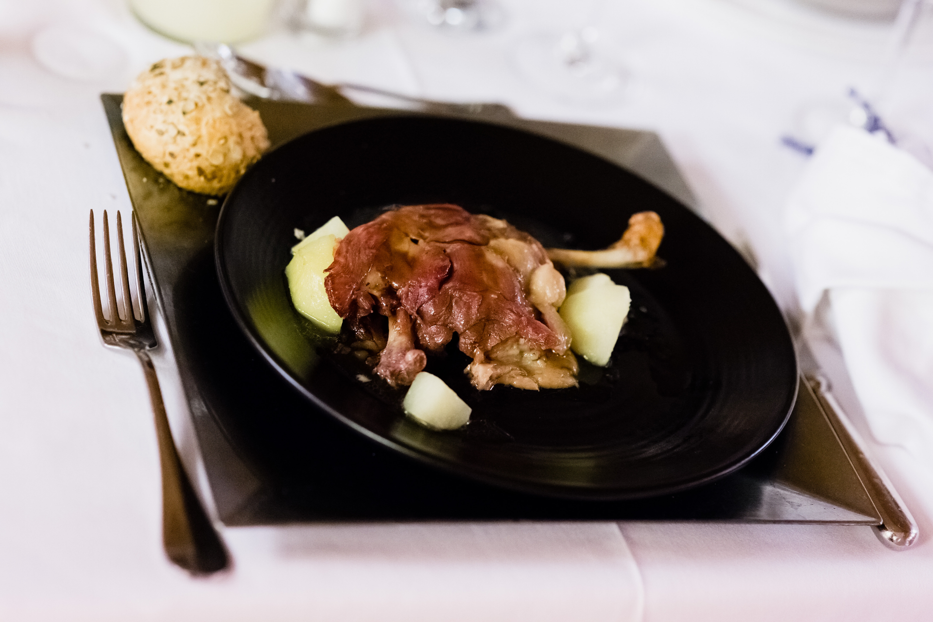 Overhead flat-lay of all ingredients for Luxurious French Duck Confit Poutine with Truffle Oil laid out on a kitchen surface.