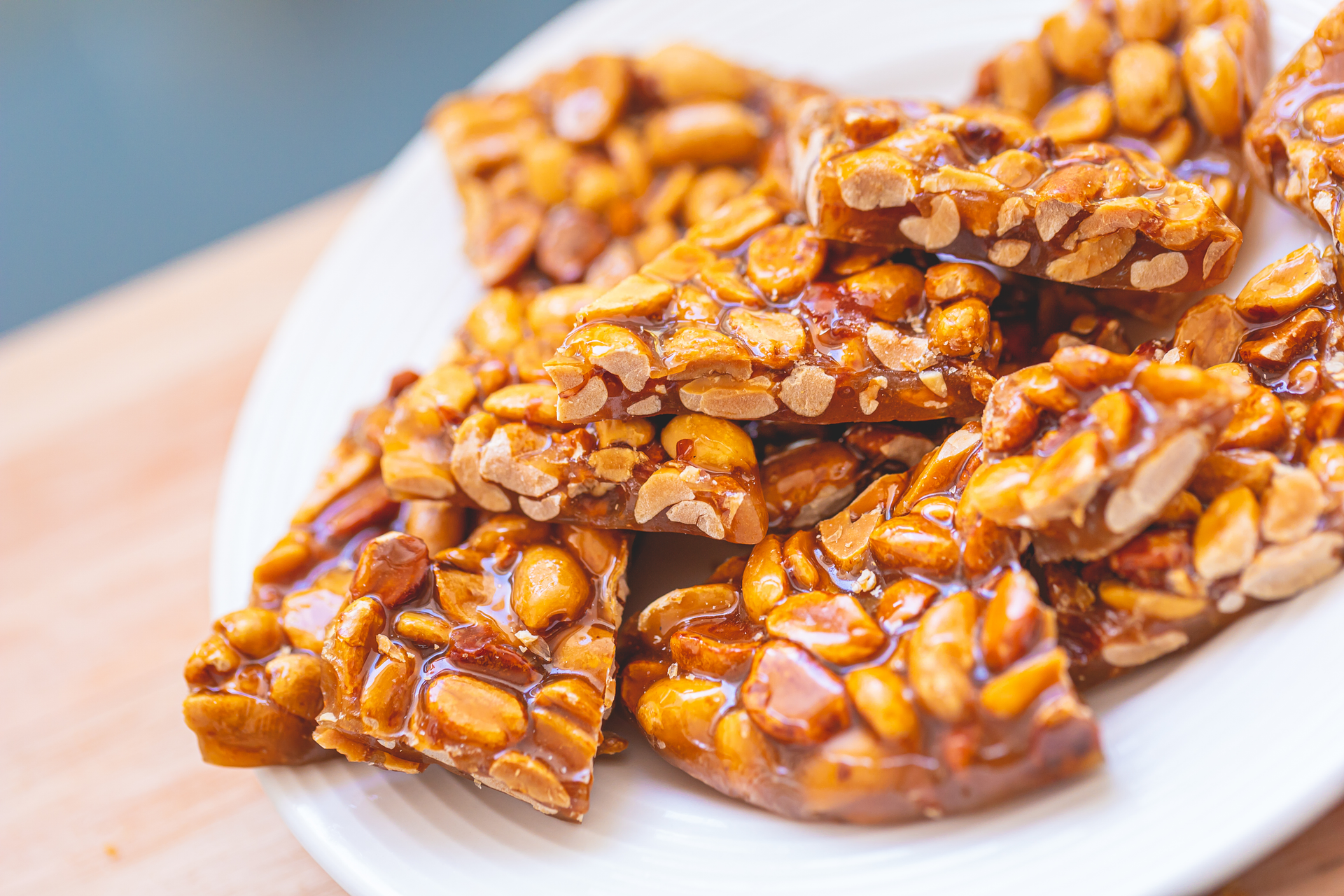 Overhead flat-lay of all ingredients for Luxurious Hawaiian Macadamia Nut Brittle with Sea Salt Caramel laid out on a kitchen surface.