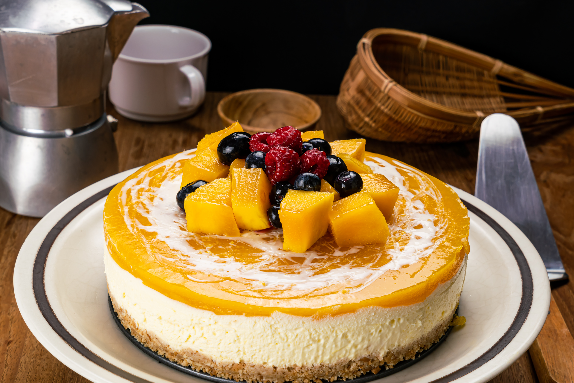 Overhead flat-lay of all ingredients for Luxurious Philippine Mango Royale Cake with Cashew Cream laid out on a kitchen surface.